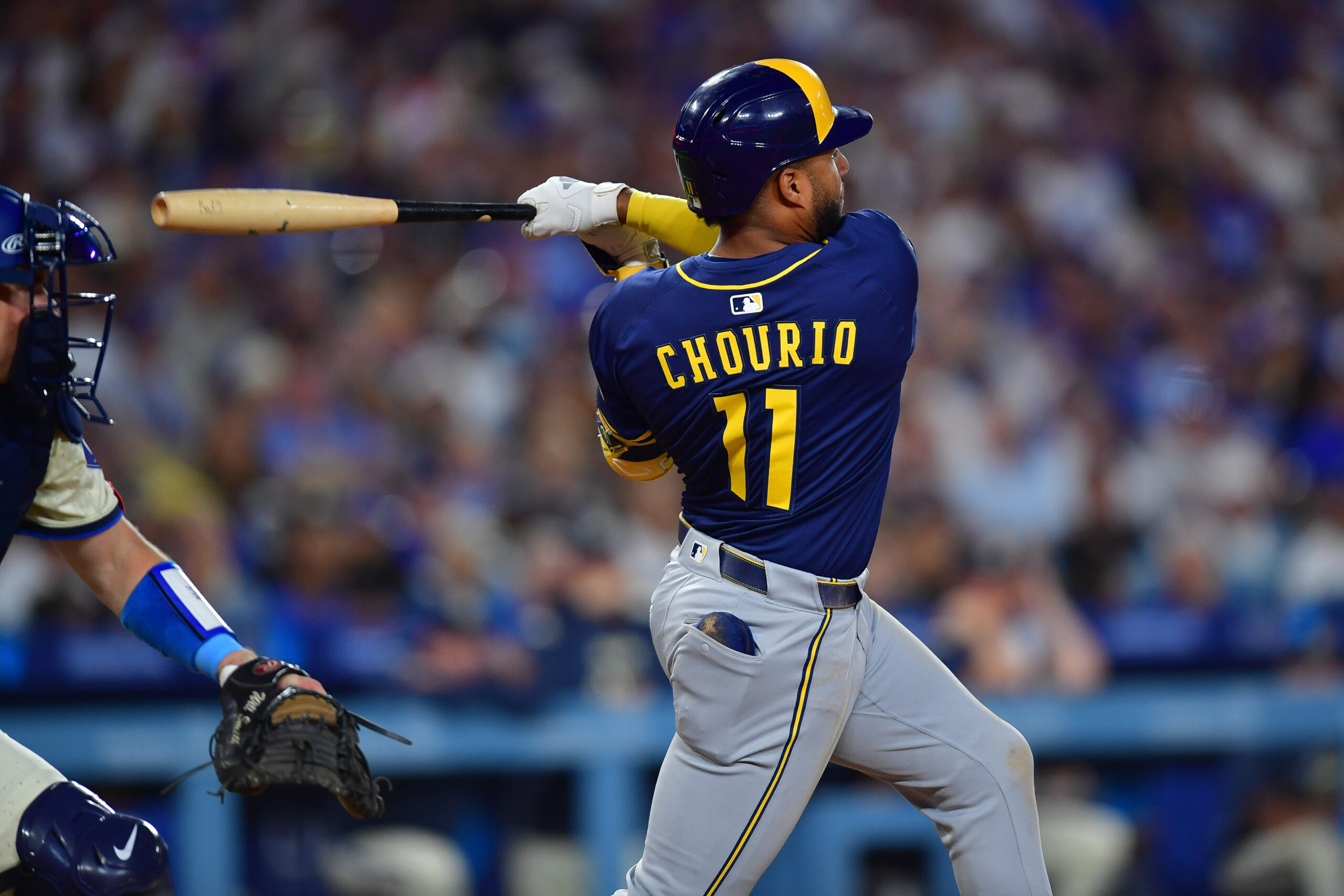 Jul 19, 2025; Los Angeles, California, USA; Milwaukee Brewers right fielder Jackson Chourio (11) hits a single against the Los Angeles Dodgers during the seventh inning at Dodger Stadium. Mandatory Credit: Gary A. Vasquez-Imagn Images