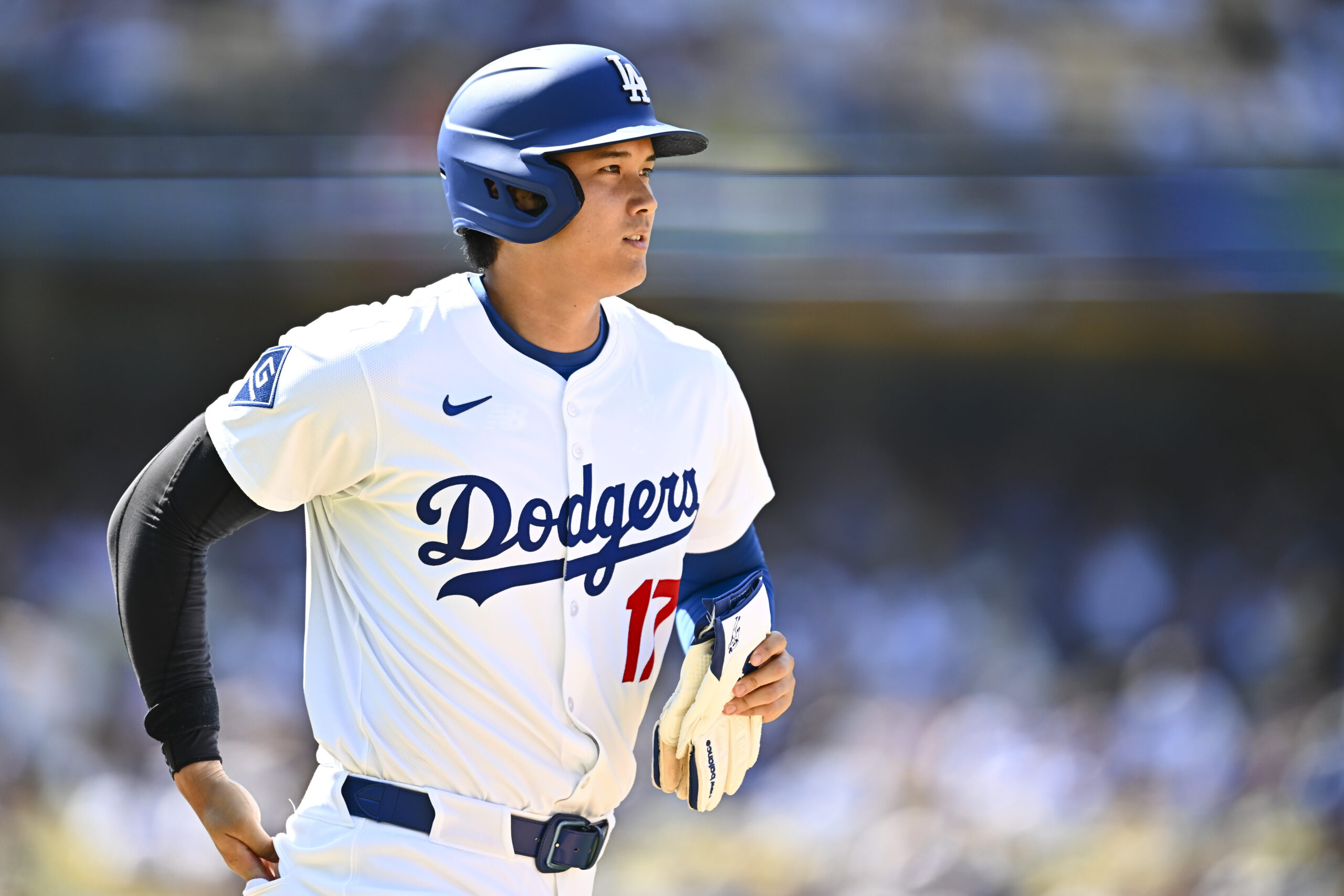 Jul 20, 2025; Los Angeles, California, USA; Los Angeles Dodgers designated hitter Shohei Ohtani (17) heads to first base after a walk against the Milwaukee Brewers during the eighth inning at Dodger Stadium. Mandatory Credit: Jonathan Hui-Imagn Images
