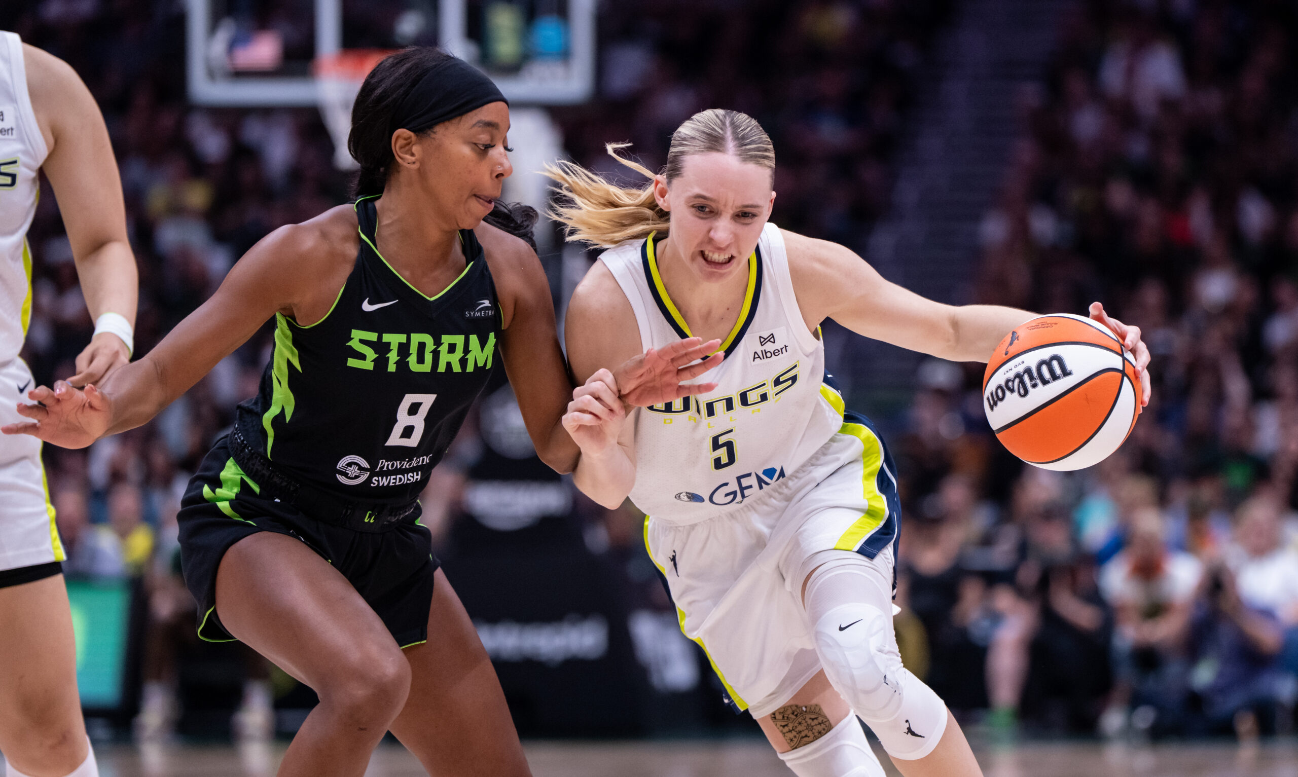Jul 22, 2025; Seattle, Washington, USA; Dallas Wings guard Paige Bueckers (5) dribbles the ball against Seattle Storm guard Lexie Brown (8) during the second half at Climate Pledge Arena. Mandatory Credit: Stephen Brashear-Imagn Images