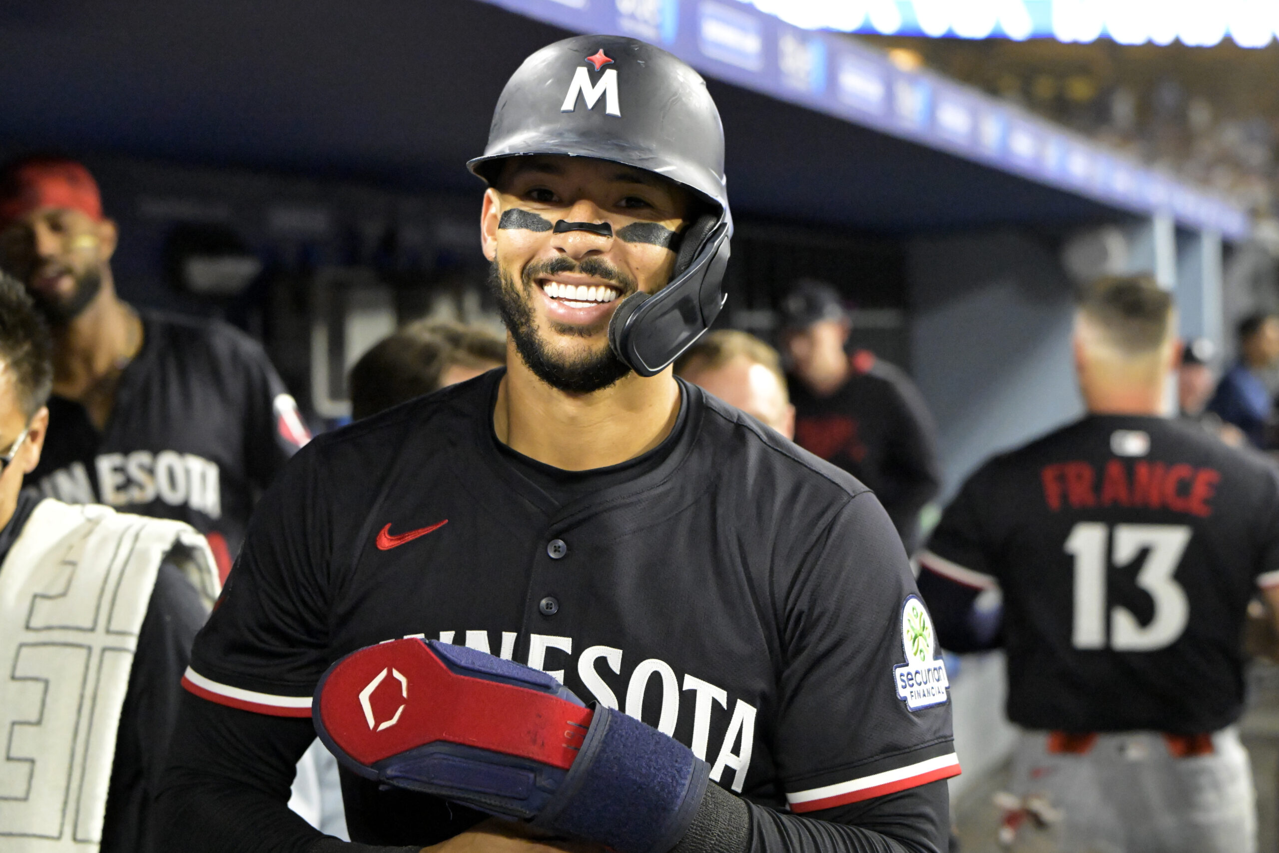 Jul 22, 2025; Los Angeles, California, USA; Minnesota Twins shortstop Carlos Correa (4) in the dugout after scoring a run against the Los Angeles Dodgers at Dodger Stadium. Mandatory Credit: Jayne Kamin-Oncea-Imagn Images