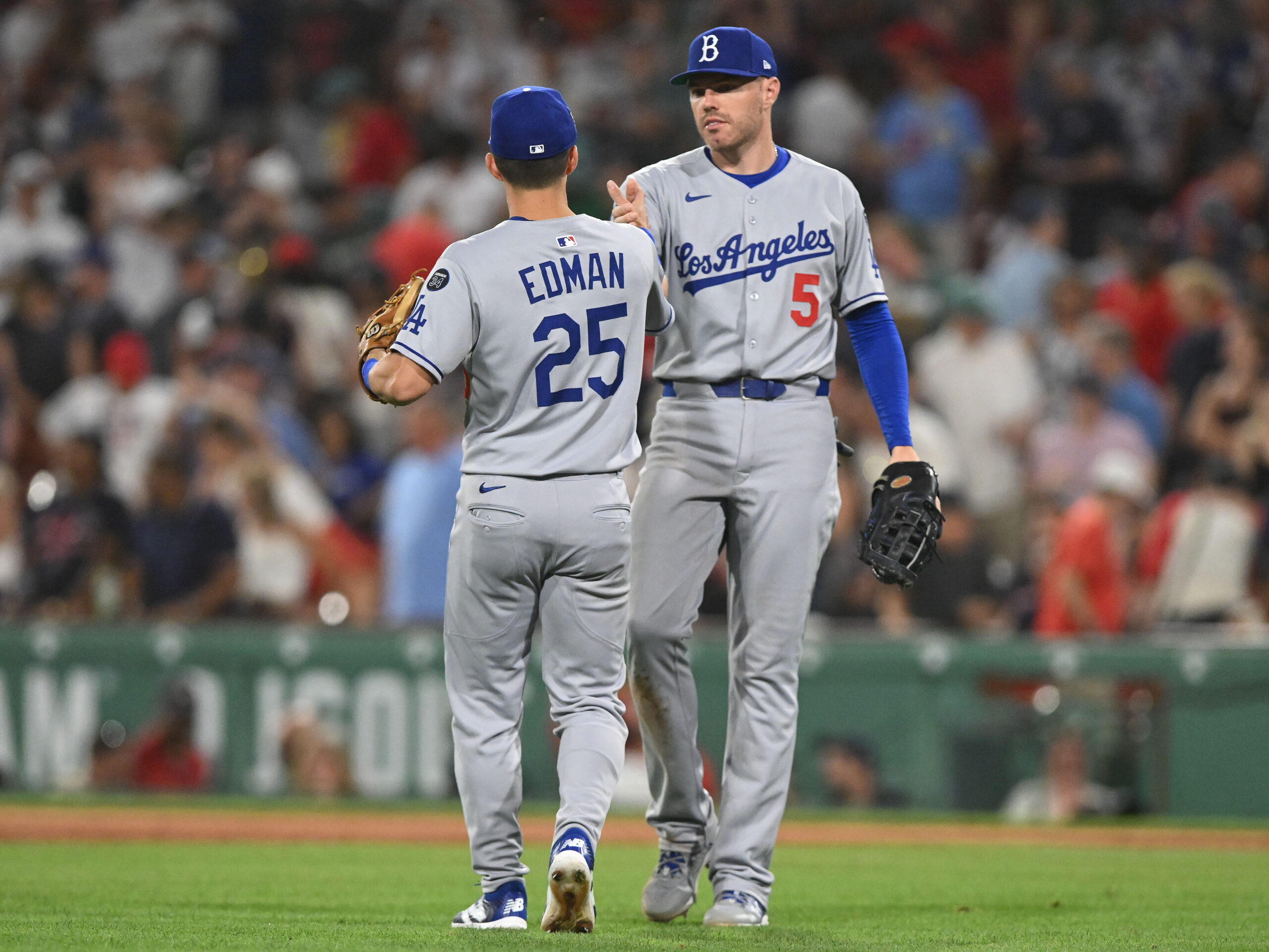 Jul 25, 2025; Boston, Massachusetts, USA; Los Angeles Dodgers first baseman Freddie Freeman (5) high-fives second baseman Tommy Edman (25) after a game against the Boston Red Sox at Fenway Park. Mandatory Credit: Brian Fluharty-Imagn Images