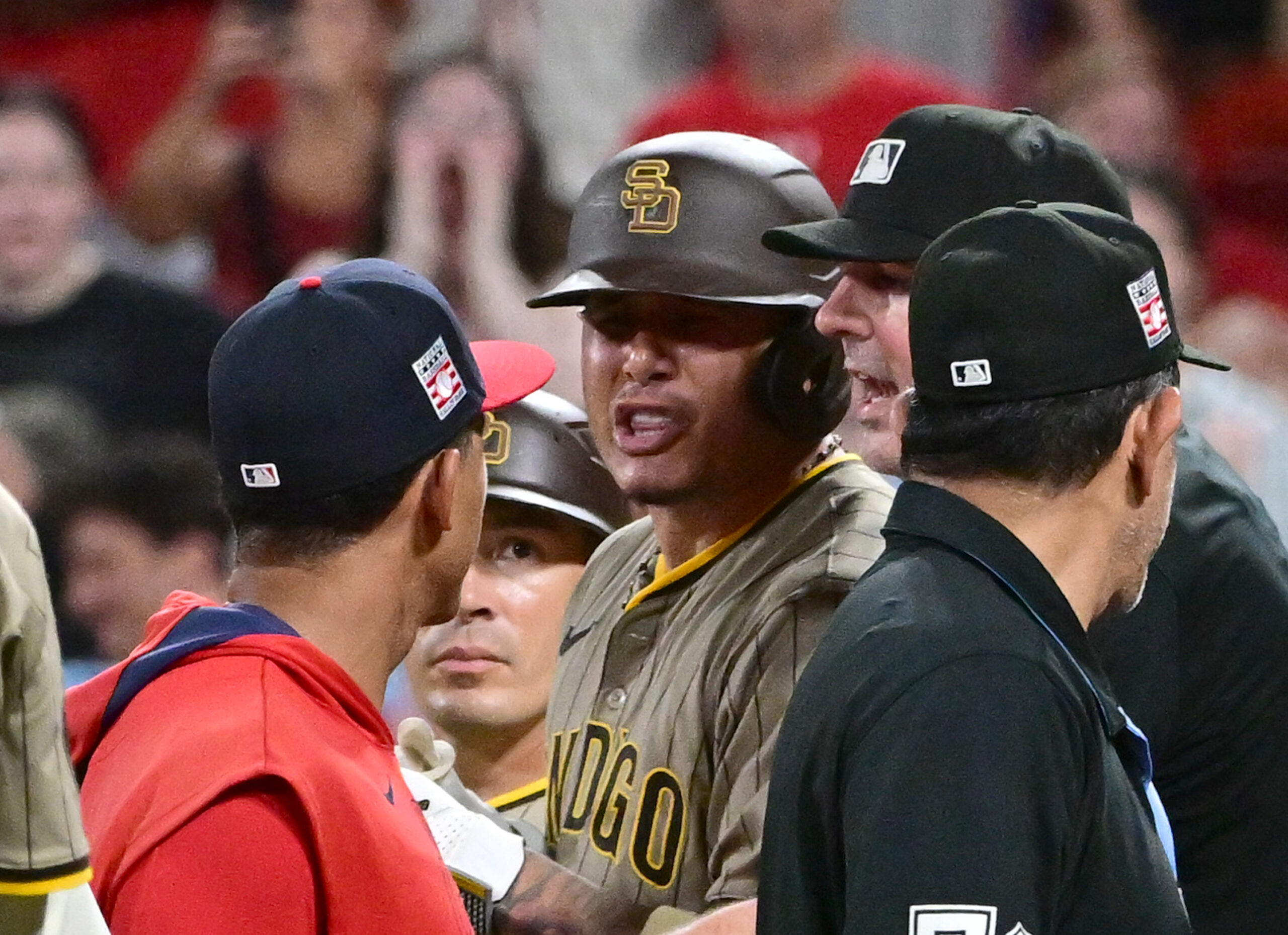 Jul 26, 2025; St. Louis, Missouri, USA; San Diego Padres third baseman Manny Machado (13, right) exchanges words with St. Louis Cardinals coach Jon Jay (19) which lead to players from both teams cleared the dugouts in the ninth inning at Busch Stadium. Mandatory Credit: Tim Vizer-Imagn Images