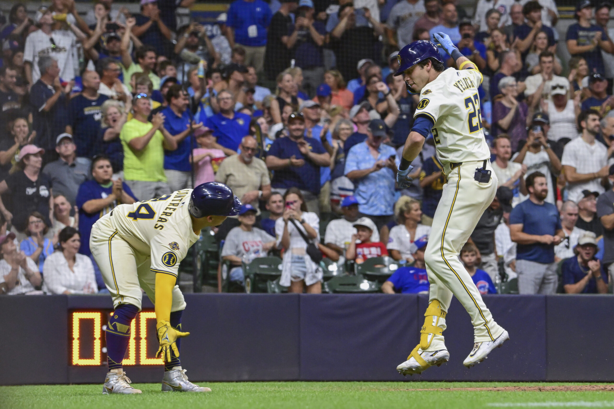 Jul 28, 2025; Milwaukee, Wisconsin, USA; Milwaukee Brewers designated hitter Christian Yelich (22) celebrates with catcher William Contreras (24) after hitting a 2-run home run in the seventh inning against the Chicago Cubs at American Family Field. Mandatory Credit: Benny Sieu-Imagn Images