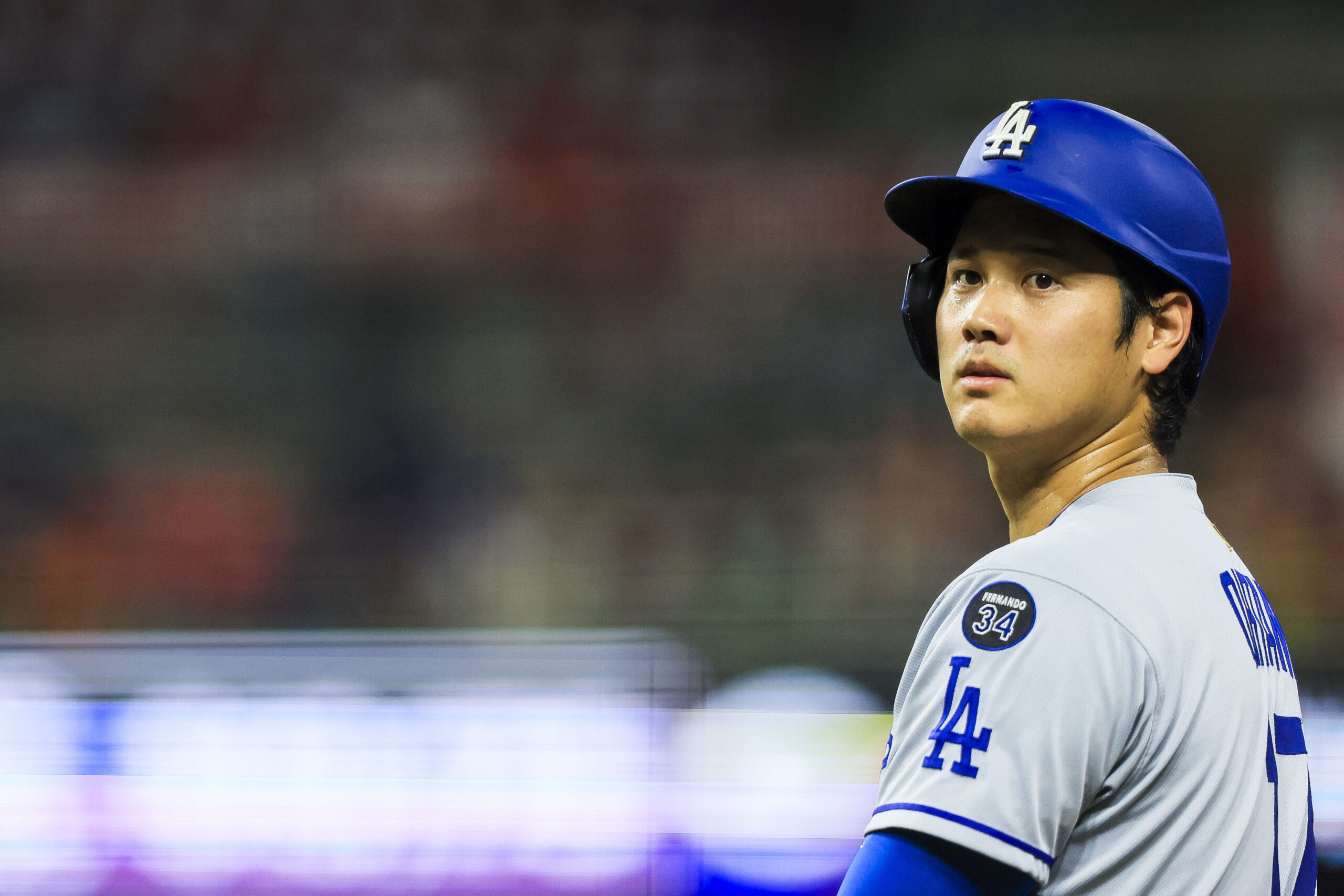 Jul 28, 2025; Cincinnati, Ohio, USA; Los Angeles Dodgers designated hitter Shohei Ohtani (17) stands on first base during a stop in play in the eighth inning against the Cincinnati Reds at Great American Ball Park. Mandatory Credit: Katie Stratman-Imagn Images