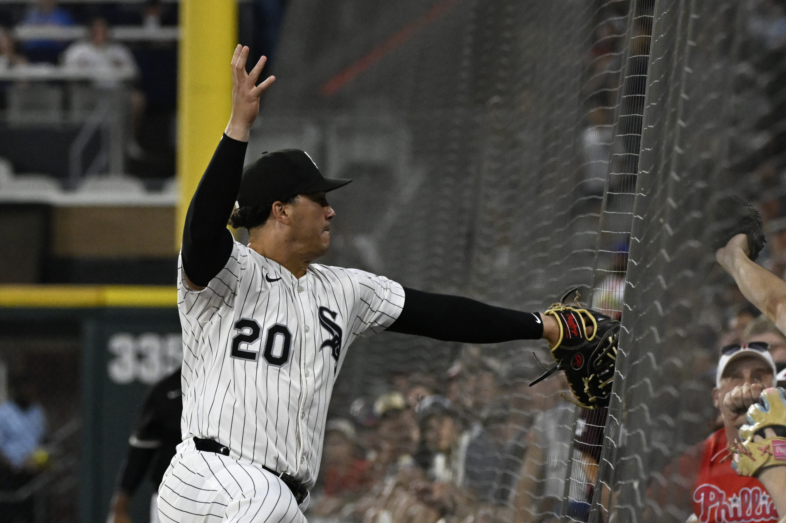 Jul 29, 2025; Chicago, Illinois, USA;  Chicago White Sox first baseman Miguel Vargas (20) tries to make the catch on the foul ball hit by Philadelphia Phillies catcher J.T. Realmuto (10) during the seventh inning at Rate Field. Mandatory Credit: Matt Marton-Imagn Images
