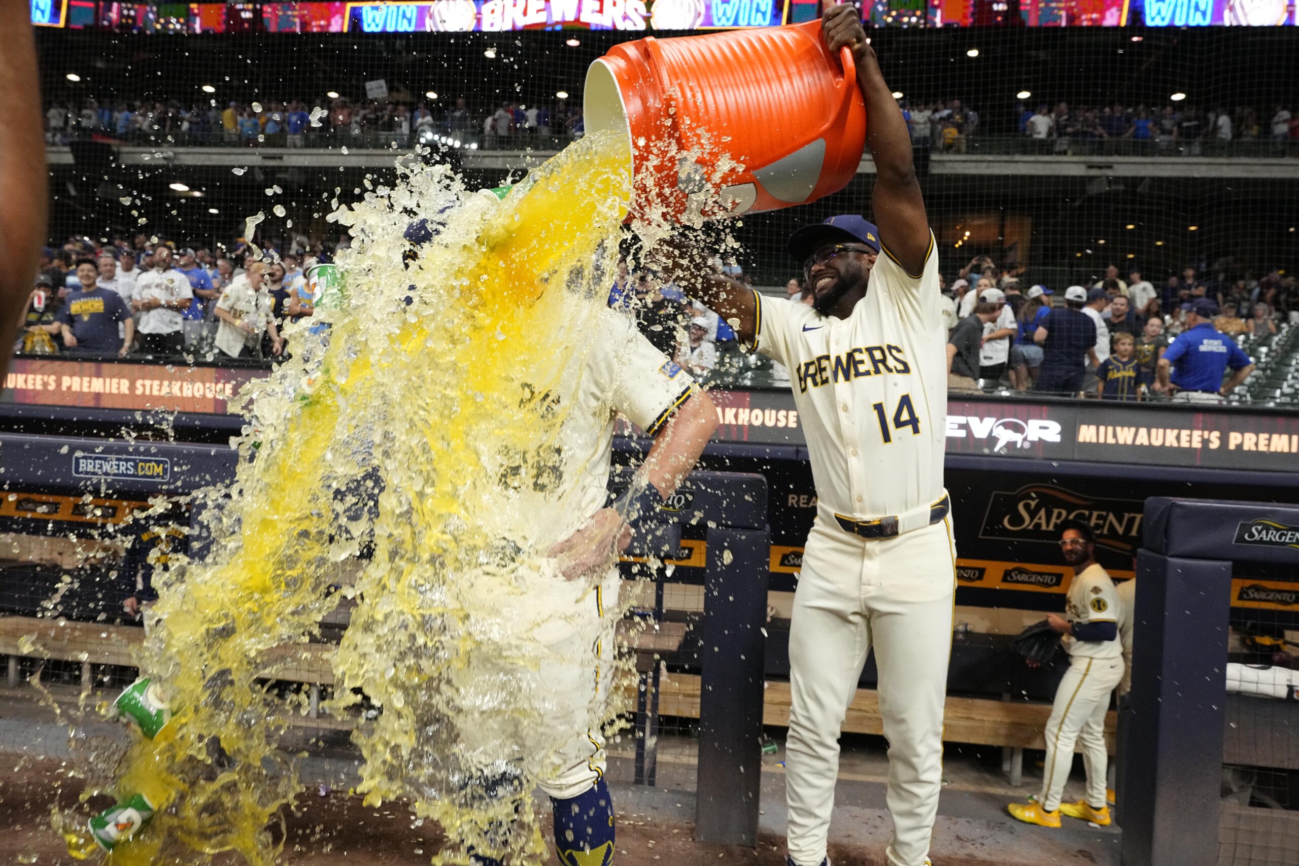 Jul 29, 2025; Milwaukee, Wisconsin, USA; Milwaukee Brewers shortstop Andruw Monasterio (14) dumps Gatorade over Milwaukee Brewers first base Andrew Vaughn (28) head after the game in which Milwaukee  Andrew Vaughn (28) hit a grand slam against the Chicago Cubs at American Family Field. Mandatory Credit: Michael McLoone-Imagn Images