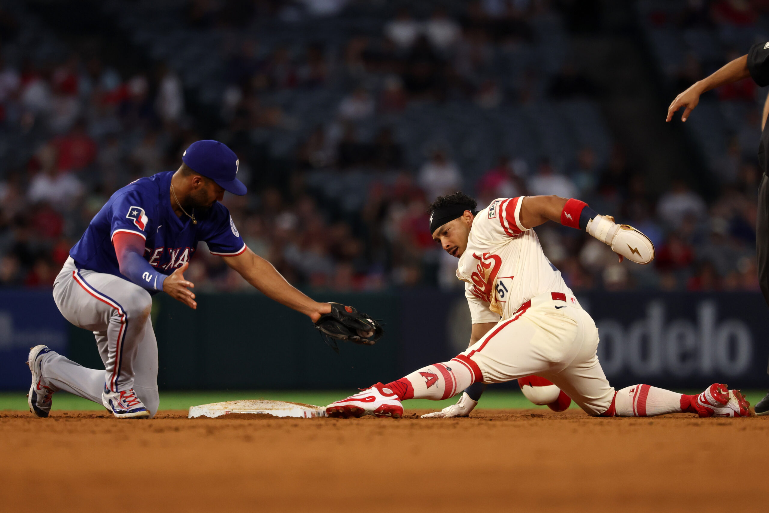 Jul 29, 2025; Anaheim, California, USA;  Los Angeles Angels right fielder Gustavo Campero (51) is tagged out by Texas Rangers second baseman Marcus Semien (2) as he tries to steal second during the fourth inning at Angel Stadium. Mandatory Credit: Kiyoshi Mio-Imagn Images
