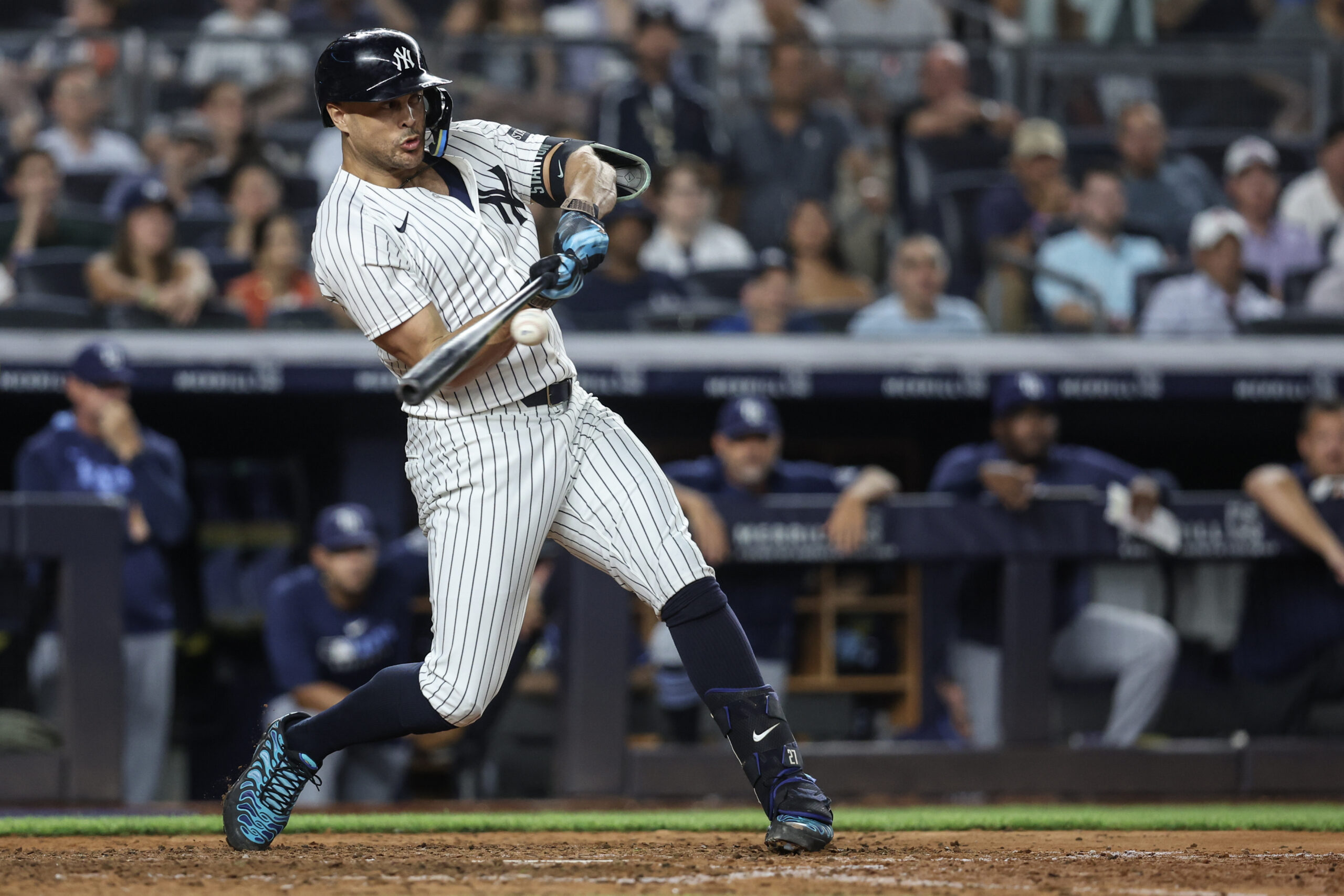Jul 30, 2025; Bronx, New York, USA;  New York Yankees designated hitter Giancarlo Stanton (27) hits an RBI single in the eighth inning against the Tampa Bay Rays at Yankee Stadium. Mandatory Credit: Wendell Cruz-Imagn Images