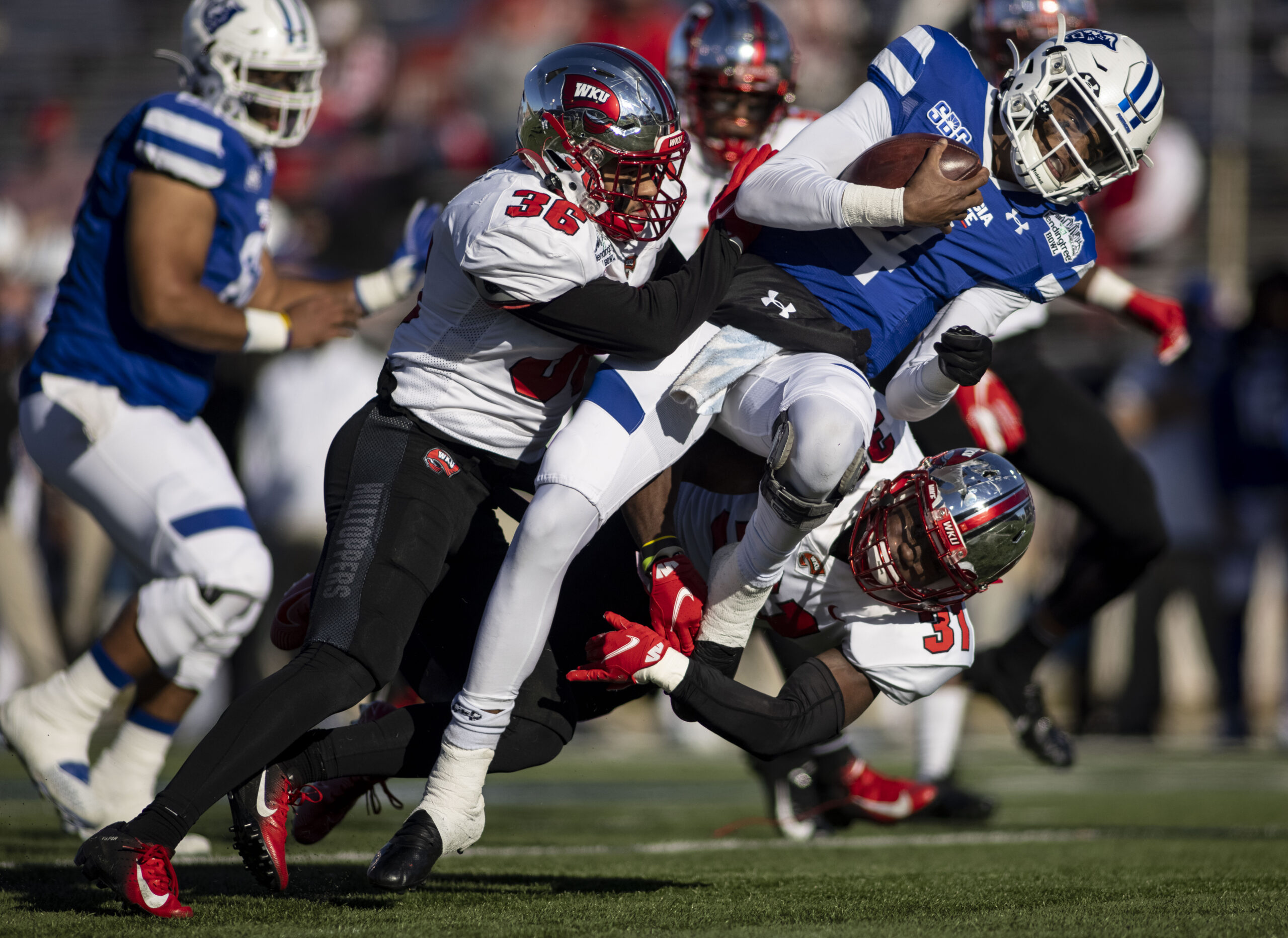 Dec 26, 2020; Mobile, AL, USA;  Western Kentucky Hilltoppers linebacker Kyle Bailey (36) and defensive back Antwon Kincade (31) hit Georgia State Panthers quarterback Cornelious Brown IV (4) during the first quarter at Ladd-Peebles Stadium. Mandatory Credit: Vasha Hunt-Imagn Images