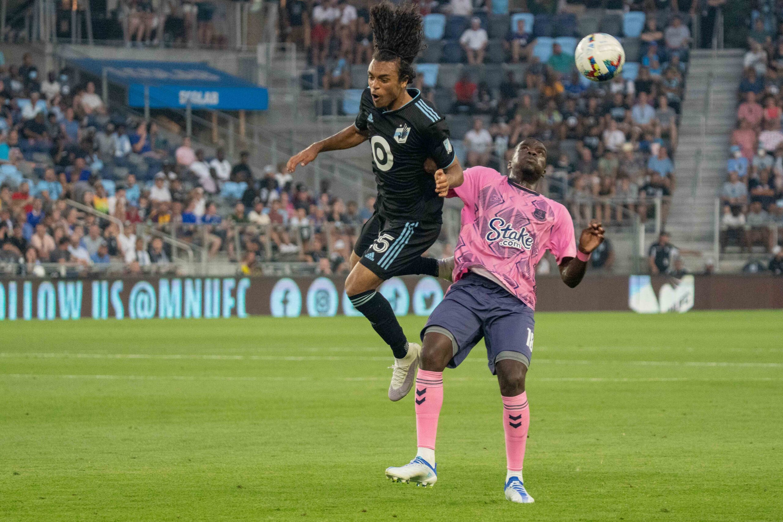 Jul 20, 2022; Minneapolis, MN, USA; Minnesota United midfielder Aziel Jackson (25) makes a play over Everton defender Niels Nkounkou (18) in the second half at Allianz Field. Mandatory Credit: Matt Blewett-Imagn Images