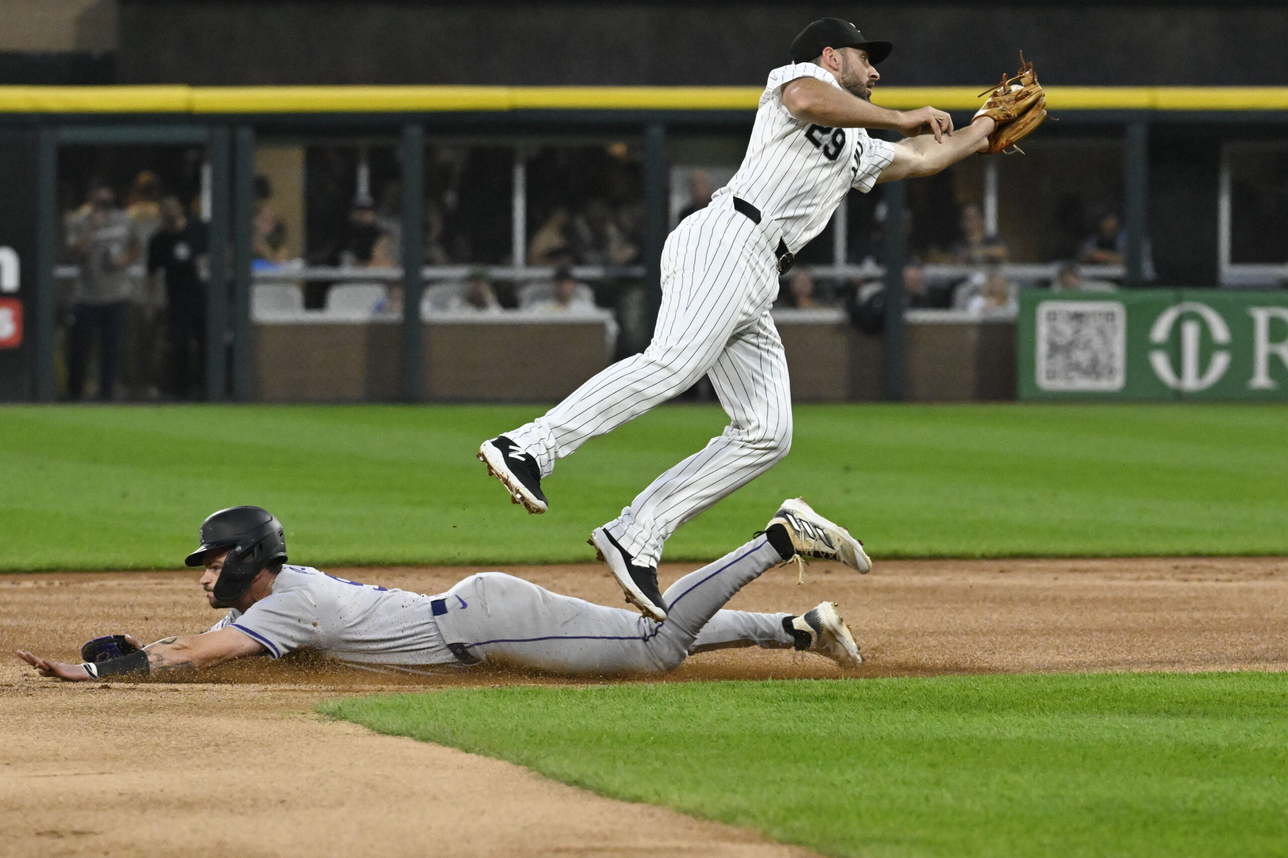 Jun 27, 2024; Chicago, Illinois, USA; Colorado Rockies outfielder Brenton Doyle (9) steals second base under Chicago White Sox shortstop Paul DeJong (29) during the first inning at Guaranteed Rate Field. Mandatory Credit: Matt Marton-Imagn Images