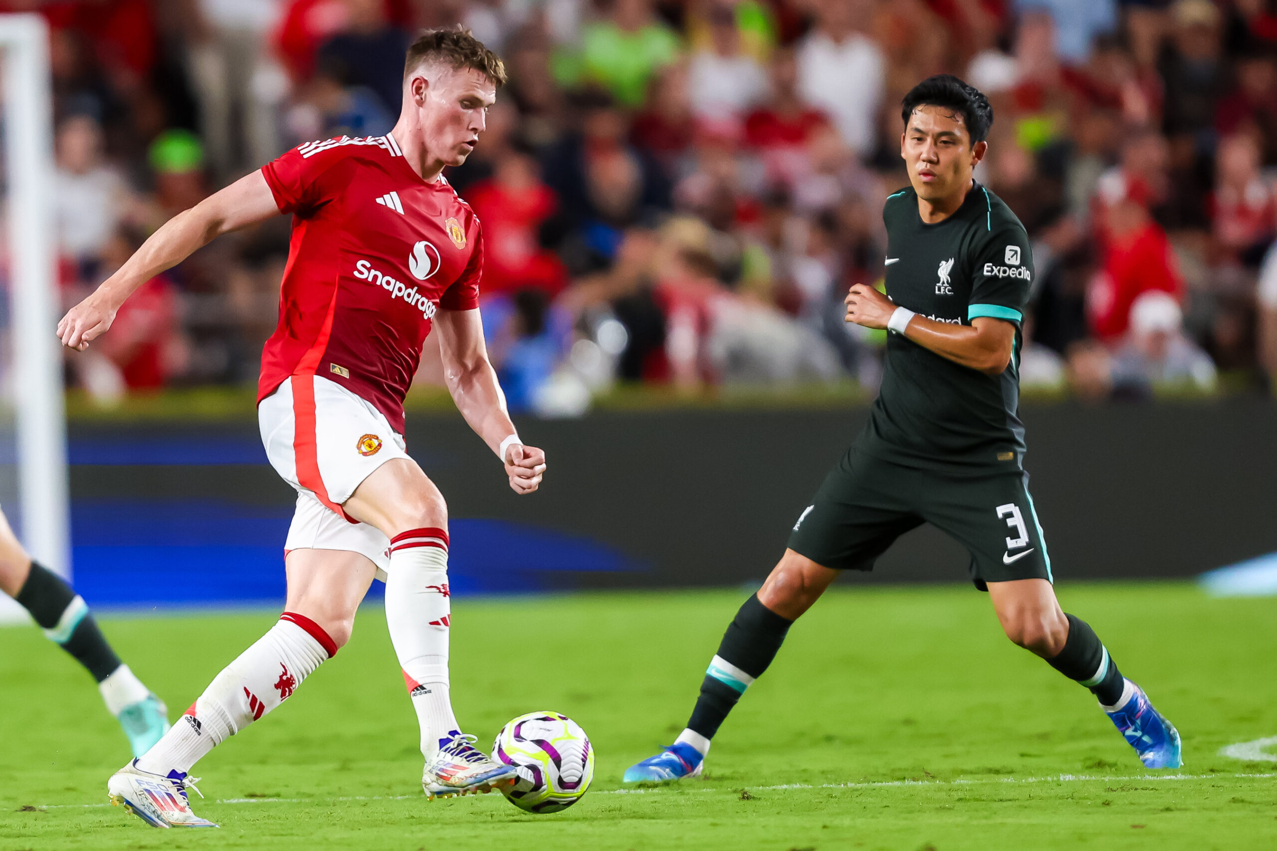 Aug 3, 2024; Columbia, South Carolina, USA; Manchester United midfielder Scott McTominay (39) drives past Liverpool midfielder Wataru Endo (3) in the second half at Williams-Brice Stadium. Mandatory Credit: Jeff Blake-Imagn Images