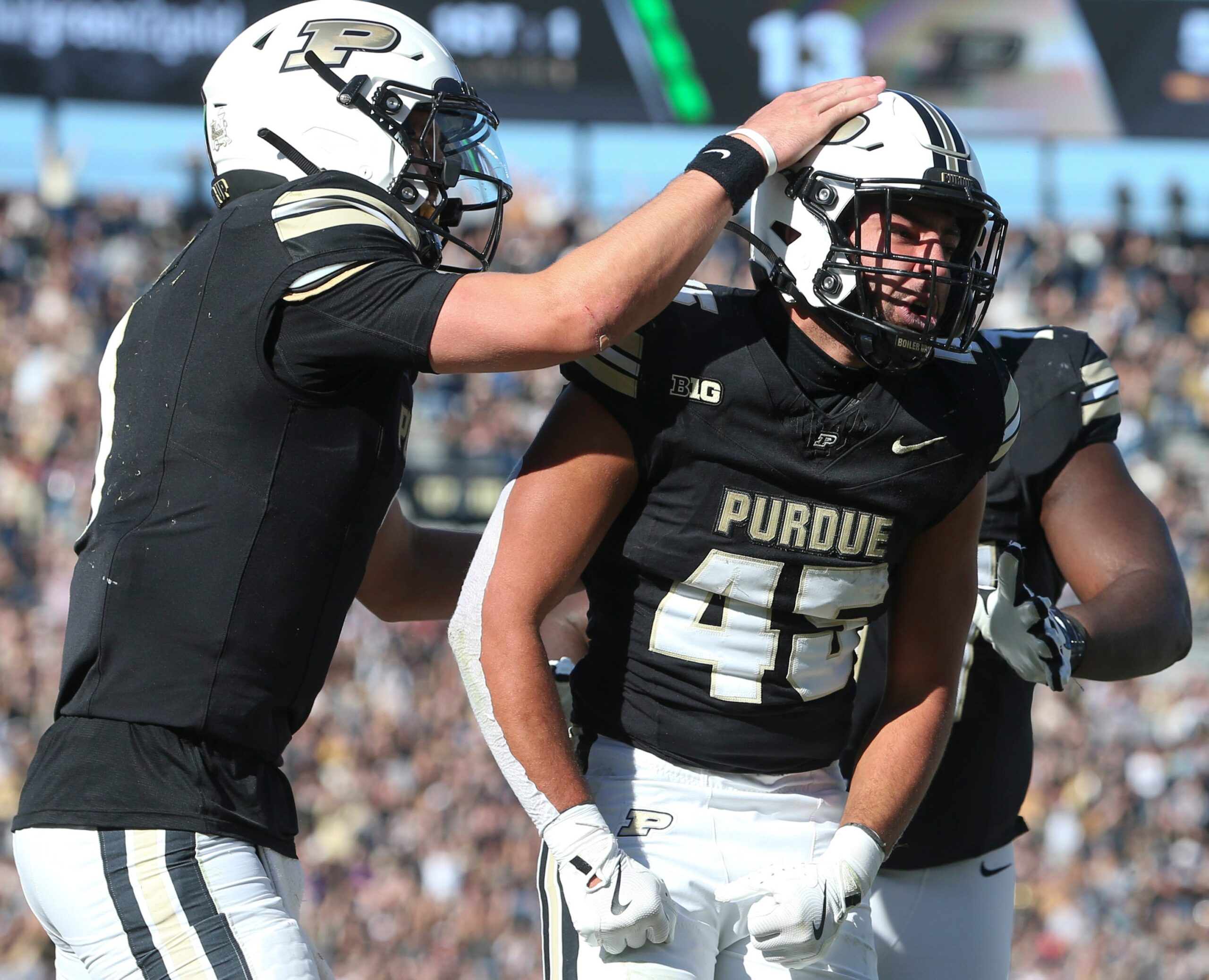 Purdue Boilermakers running back Devin Mockobee (45) celebrates with Purdue Boilermakers quarterback Hudson Card (1) and Purdue Boilermakers offensive lineman Jalen Grant (75) after scoring Saturday, Nov. 2, 2024, during the NCAA football game against the Northwestern Wildcats at Ross-Ade Stadium in West Lafayette, Ind. Northwestern Wildcats won 26-20.