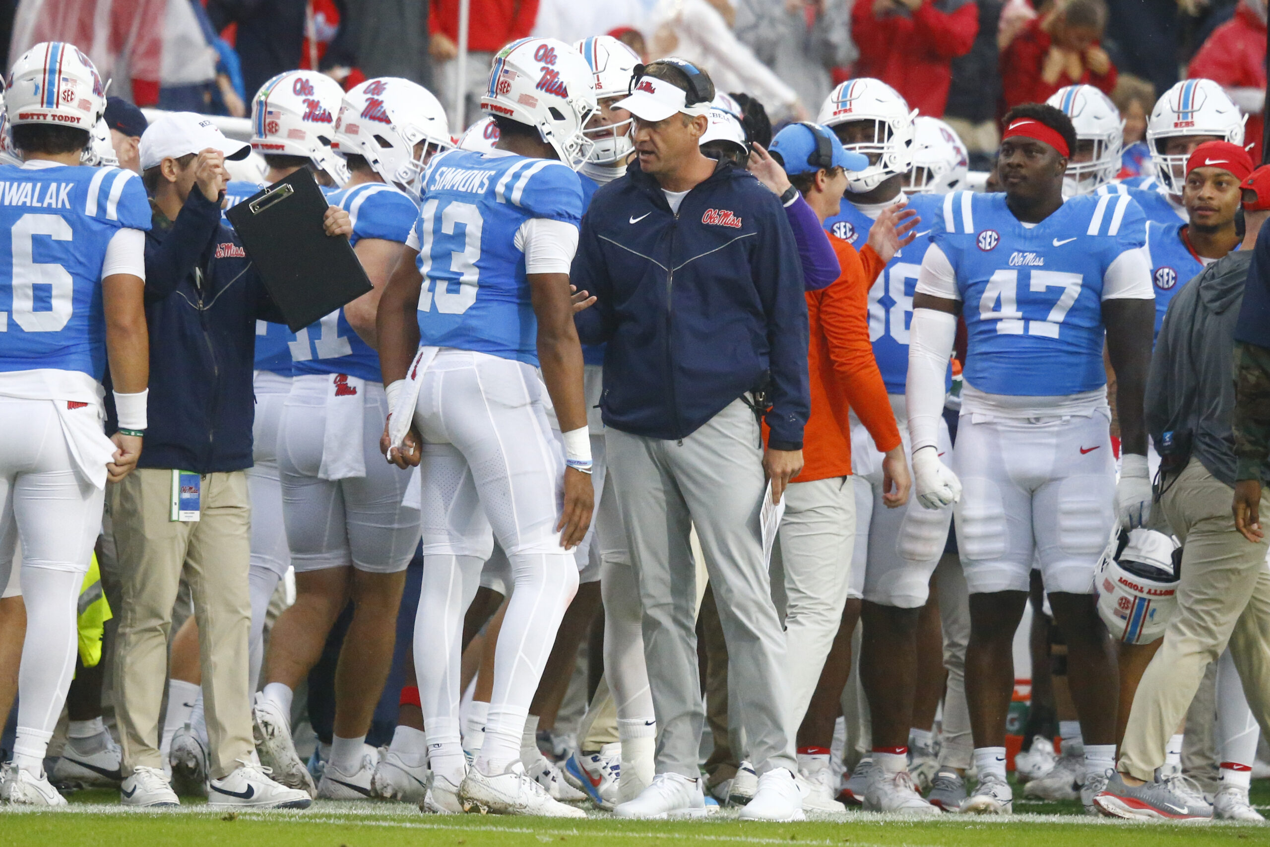Nov 9, 2024; Oxford, Mississippi, USA; Mississippi Rebels head coach Lane Kiffin talks with quarterback Austin Simmons (13) after a touchdown during the first half against the Georgia Bulldogs at Vaught-Hemingway Stadium. Mandatory Credit: Petre Thomas-Imagn Images