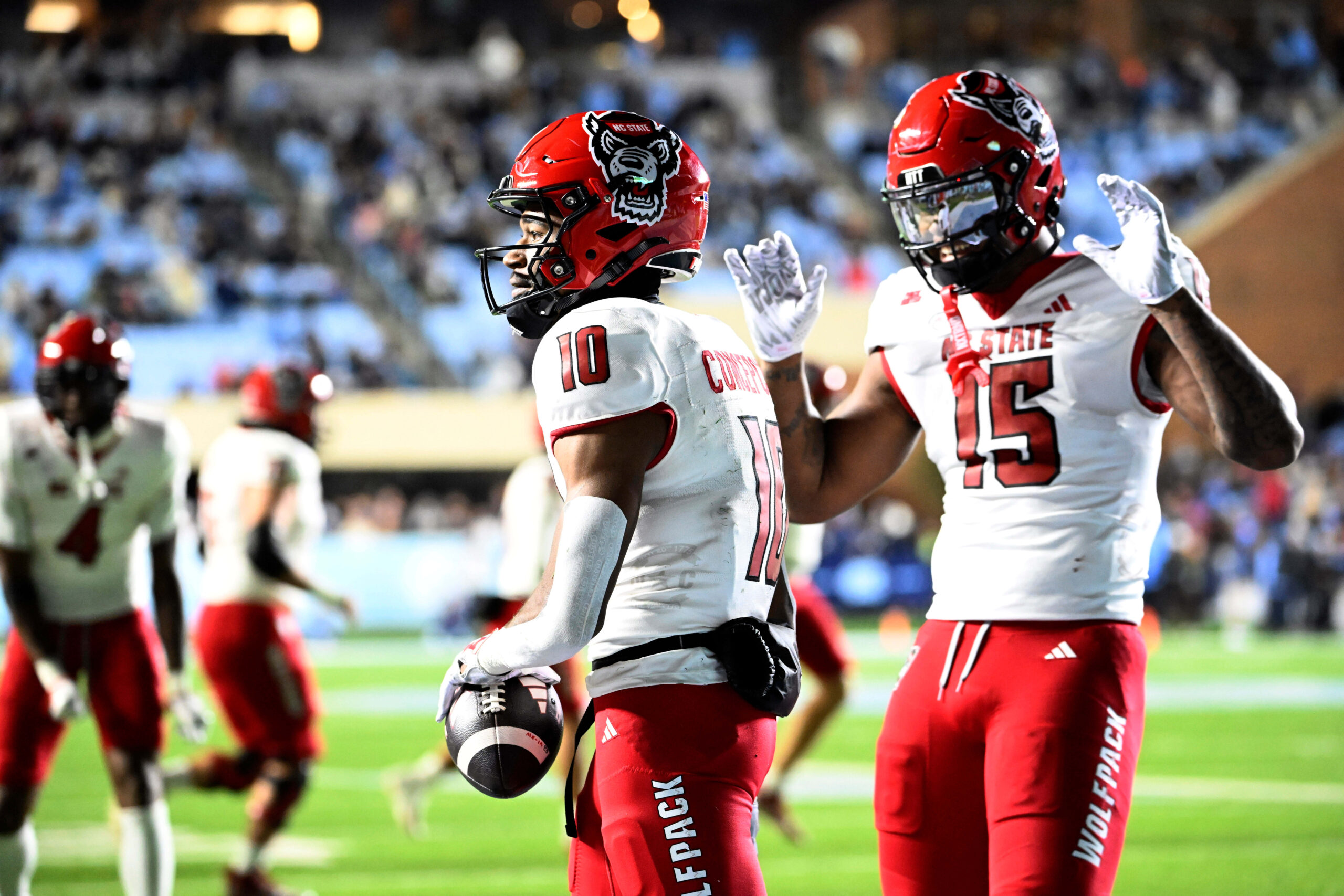 Nov 30, 2024; Chapel Hill, North Carolina, USA; North Carolina State Wolfpack wide receiver Kevin Concepcion (10) celebrates with North Carolina State Wolfpack tight end Justin Joly (15) after scoring a touchdown in the fourth quarter at Kenan Memorial Stadium. Mandatory Credit: Bob Donnan-Imagn Images