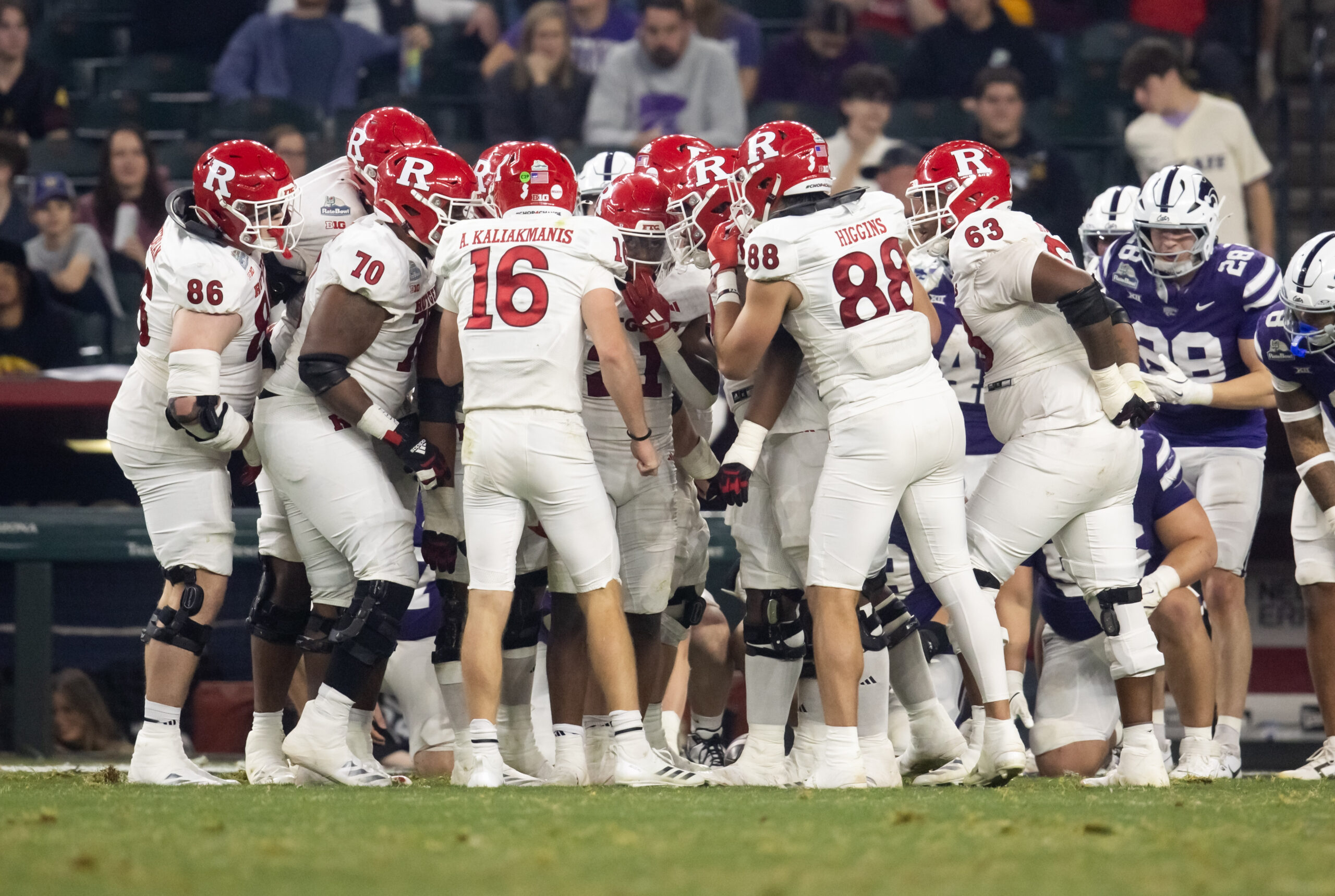 Dec 26, 2024; Phoenix, AZ, USA; Rutgers Scarlet Knights quarterback Athan Kaliakmanis (16) and tight end Mike Higgins (88) in the huddle with teammates against the Kansas State Wildcats during the Rate Bowl at Chase Field. Mandatory Credit: Mark J. Rebilas-Imagn Images