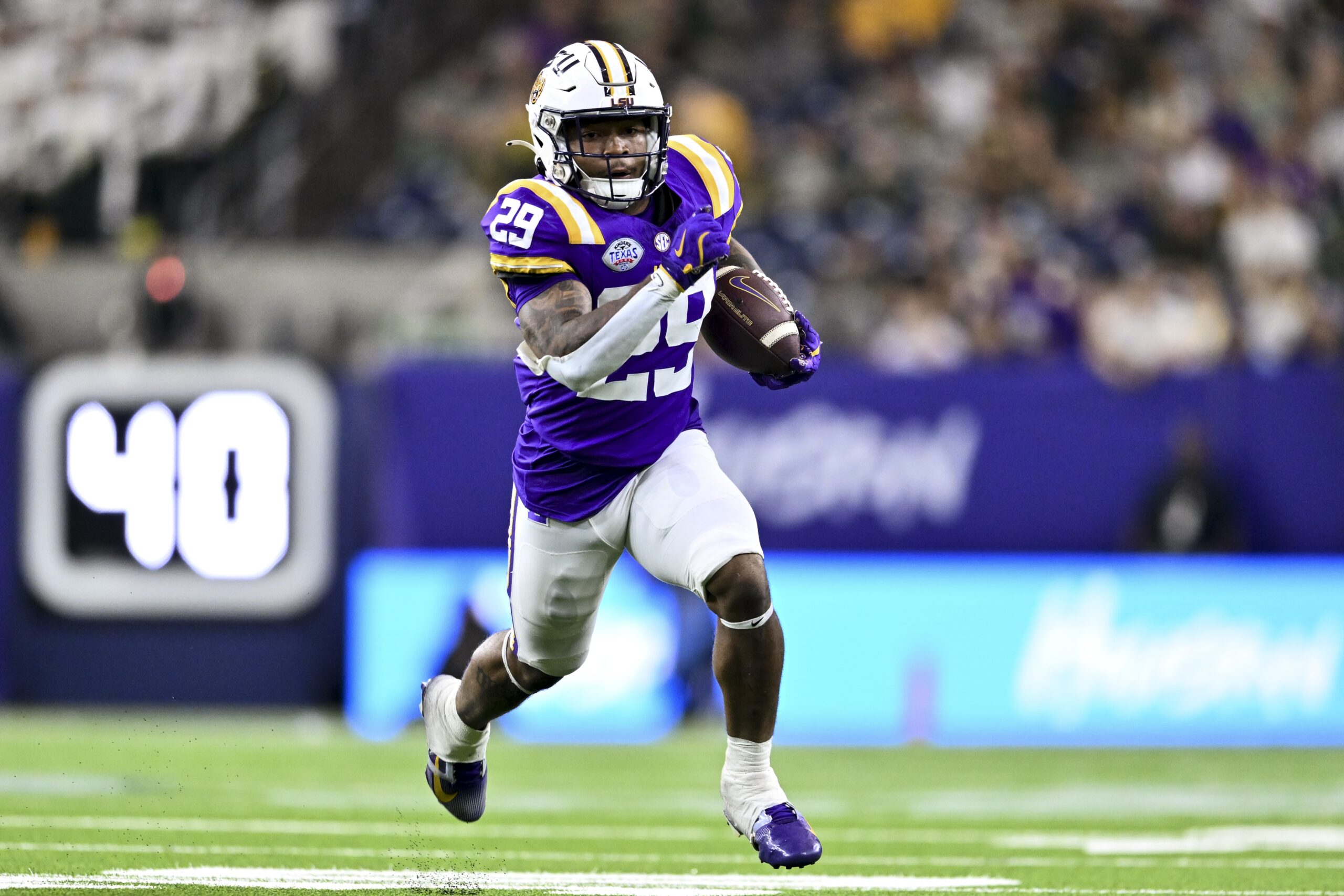 Dec 31, 2024; Houston, TX, USA; LSU Tigers running back Caden Durham (29) runs the ball during the second half against the Baylor Bears at NRG Stadium. The Tigers defeat the Bears 44-31. Mandatory Credit: Maria Lysaker-Imagn Images