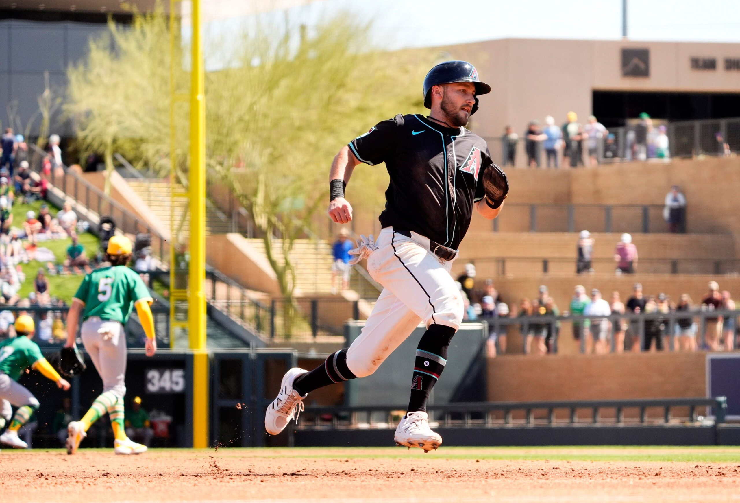 Arizona Diamondbacks 	Garrett Hampson scores on a Randal Grichuk single off Athletics starting pitcher Joey Estes in the second inning during a spring training game at Salt River Fields in Scottsdale on March 20, 2025.