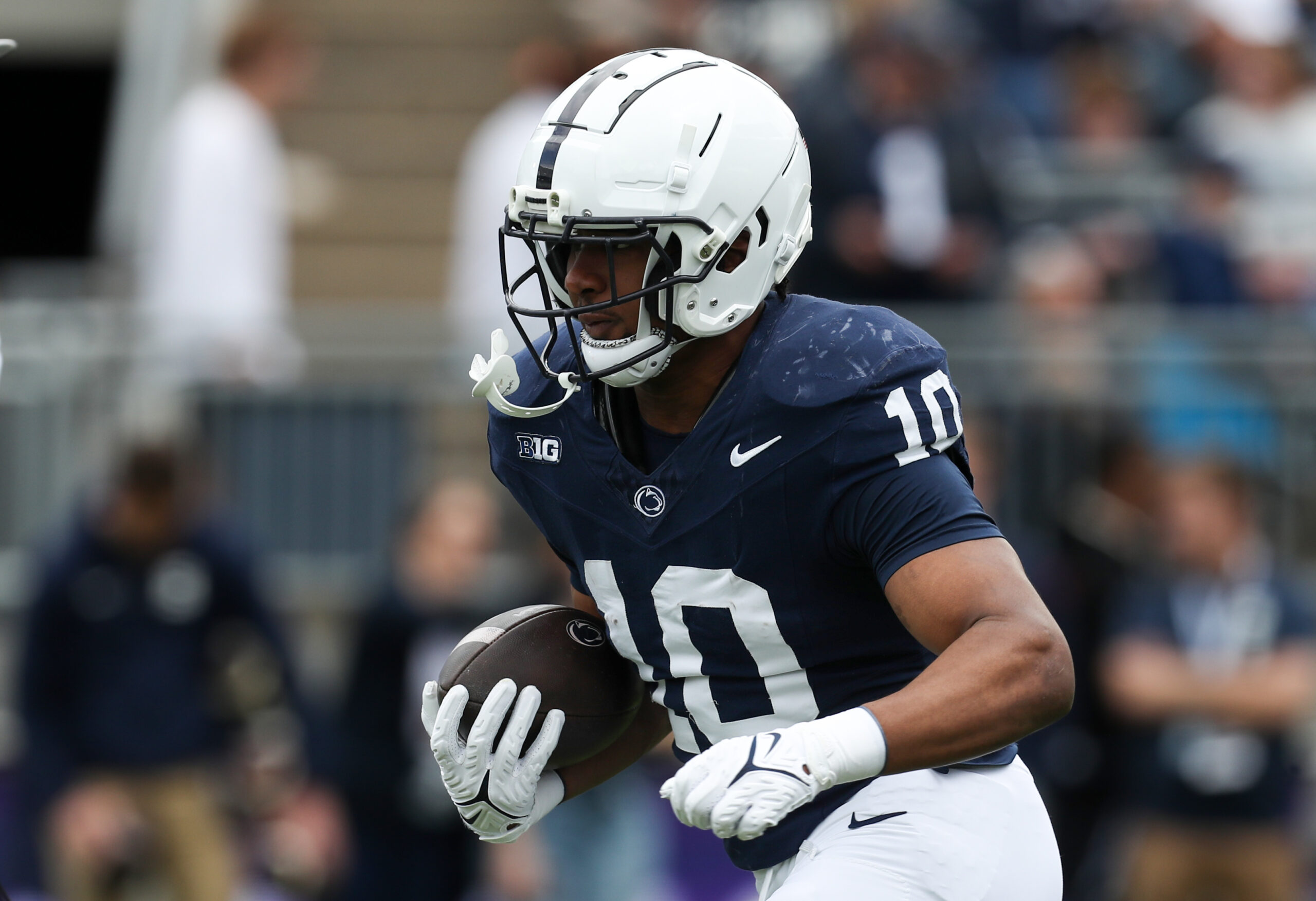 Apr 26, 2025; University Park, PA, USA; Penn State Nittany Lions running back Nicholas Singleton (10) runs a play during a warm up prior to the Blue White spring game at Beaver Stadium. Mandatory Credit: Matthew O'Haren-Imagn Images