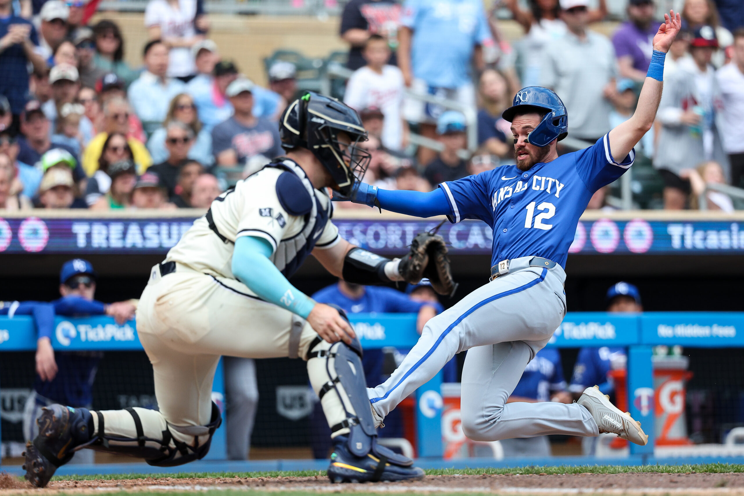 May 25, 2025; Minneapolis, Minnesota, USA; Kansas City Royals left fielder Nick Loftin (12) scores the go ahead run on a double hit third baseman Maikel Garcia (11) during the tenth inning against the Minnesota Twins at Target Field. Mandatory Credit: Matt Krohn-Imagn Images