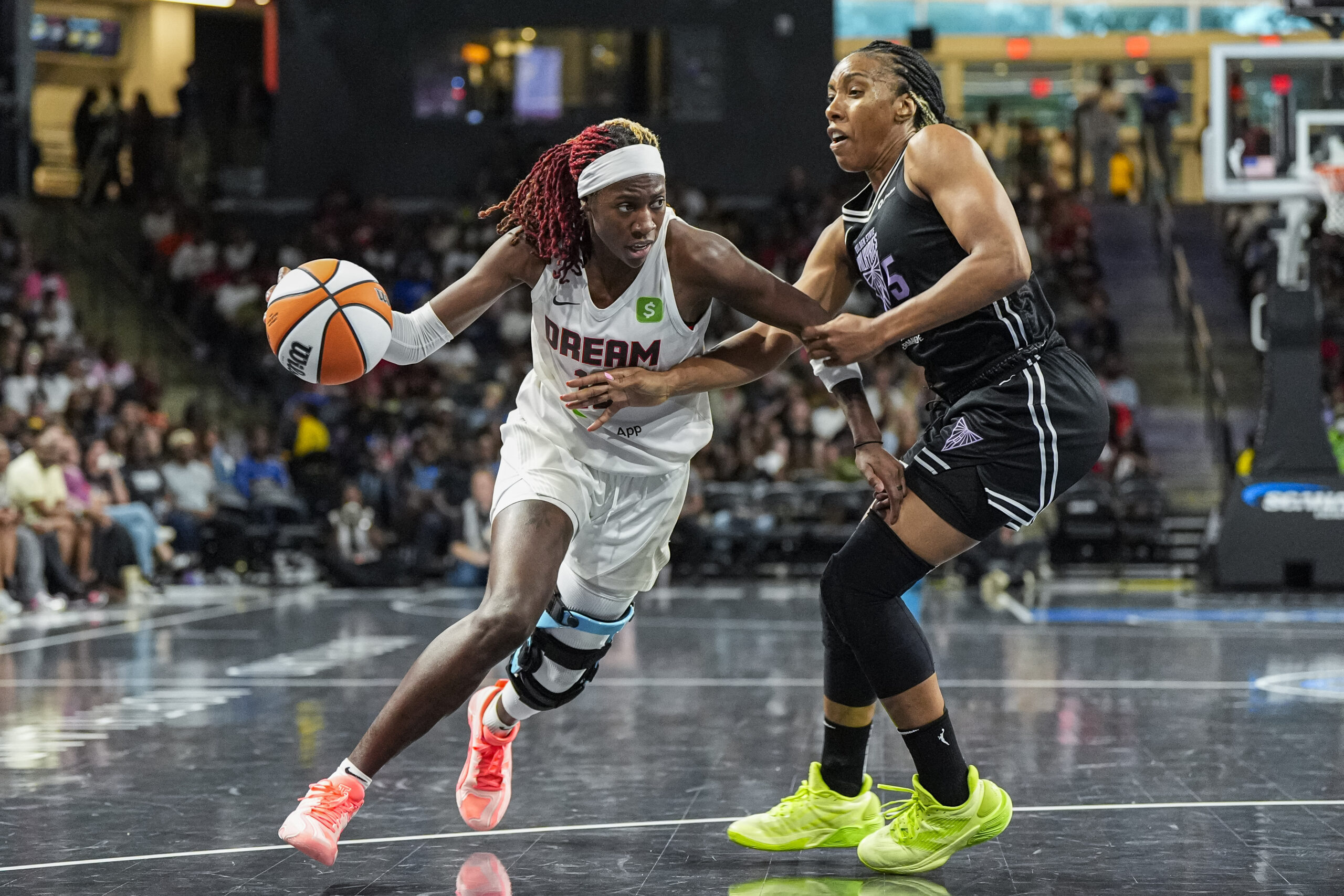 Jul 7, 2025; College Park, Georgia, USA; Atlanta Dream guard Rhyne Howard (10) dribbles against Golden State Valkyries forward Kayla Thornton (5) during the second half at Gateway Center Arena at College Park. Mandatory Credit: Dale Zanine-Imagn Images