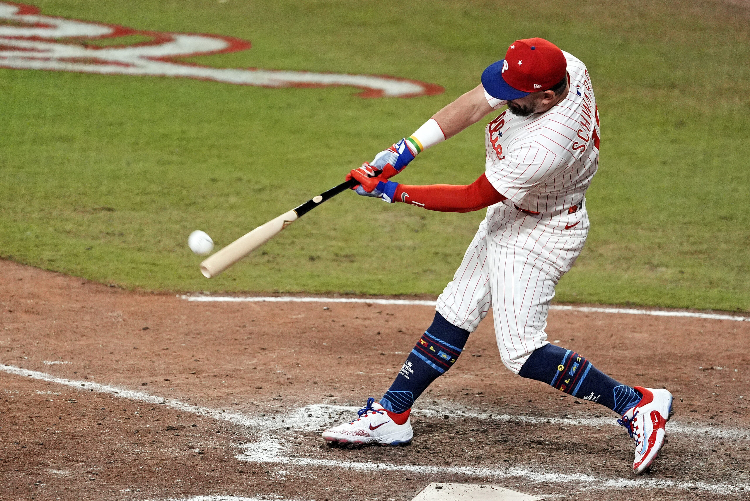 Jul 15, 2025; Cumberland, Georgia, USA; National League designated hitter Kyle Schwarber (12) of the Philadelphia Phillies hits a home run in the swing off of after the 2025 MLB All Star Game ended in a tie at Truist Park. Mandatory Credit: Dale Zanine-Imagn Images