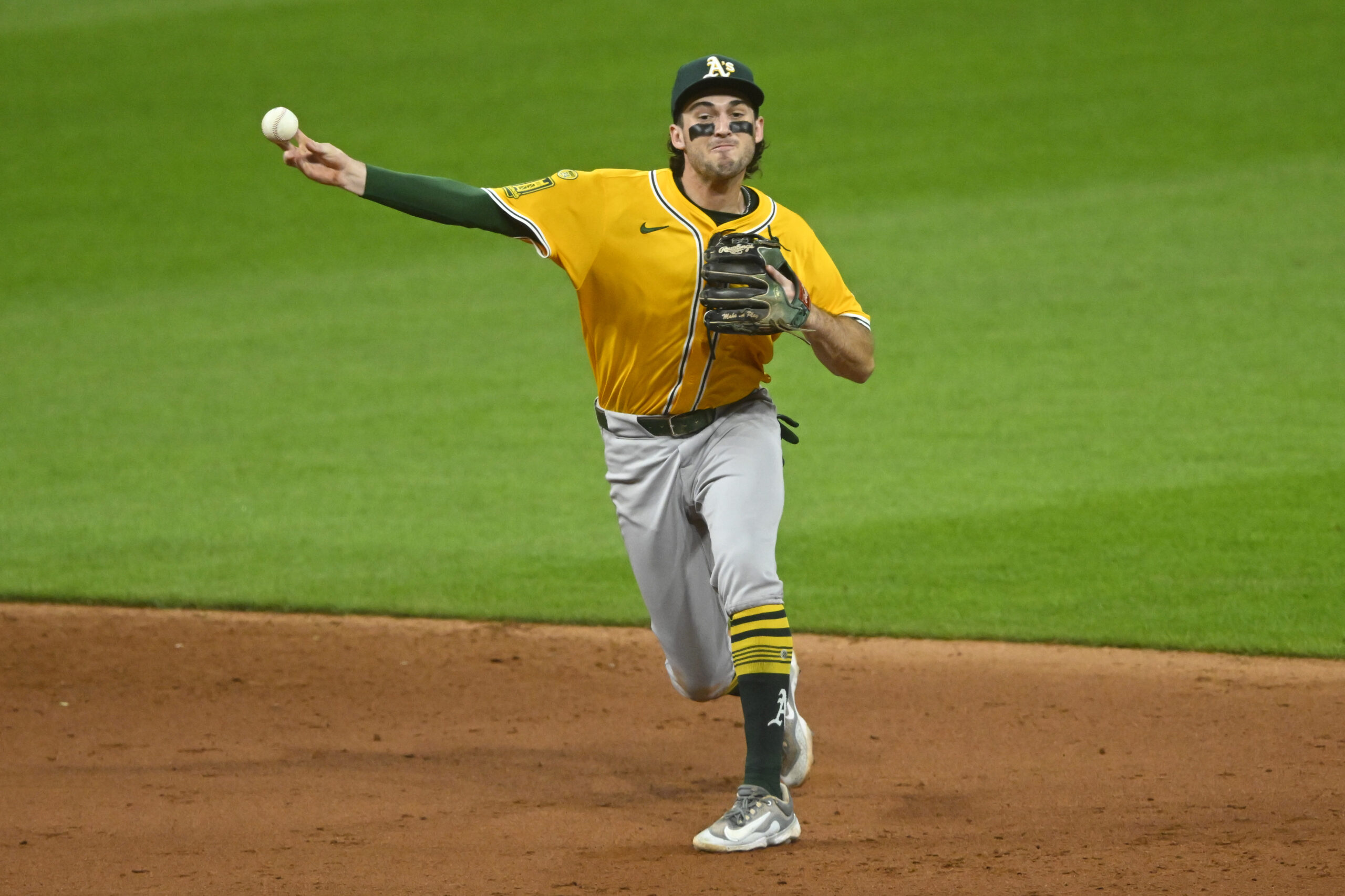 Jul 19, 2025; Cleveland, Ohio, USA; Athletics shortstop Jacob Wilson (5) throws to first base in the sixth inning against the Cleveland Guardians at Progressive Field. Mandatory Credit: David Richard-Imagn Images