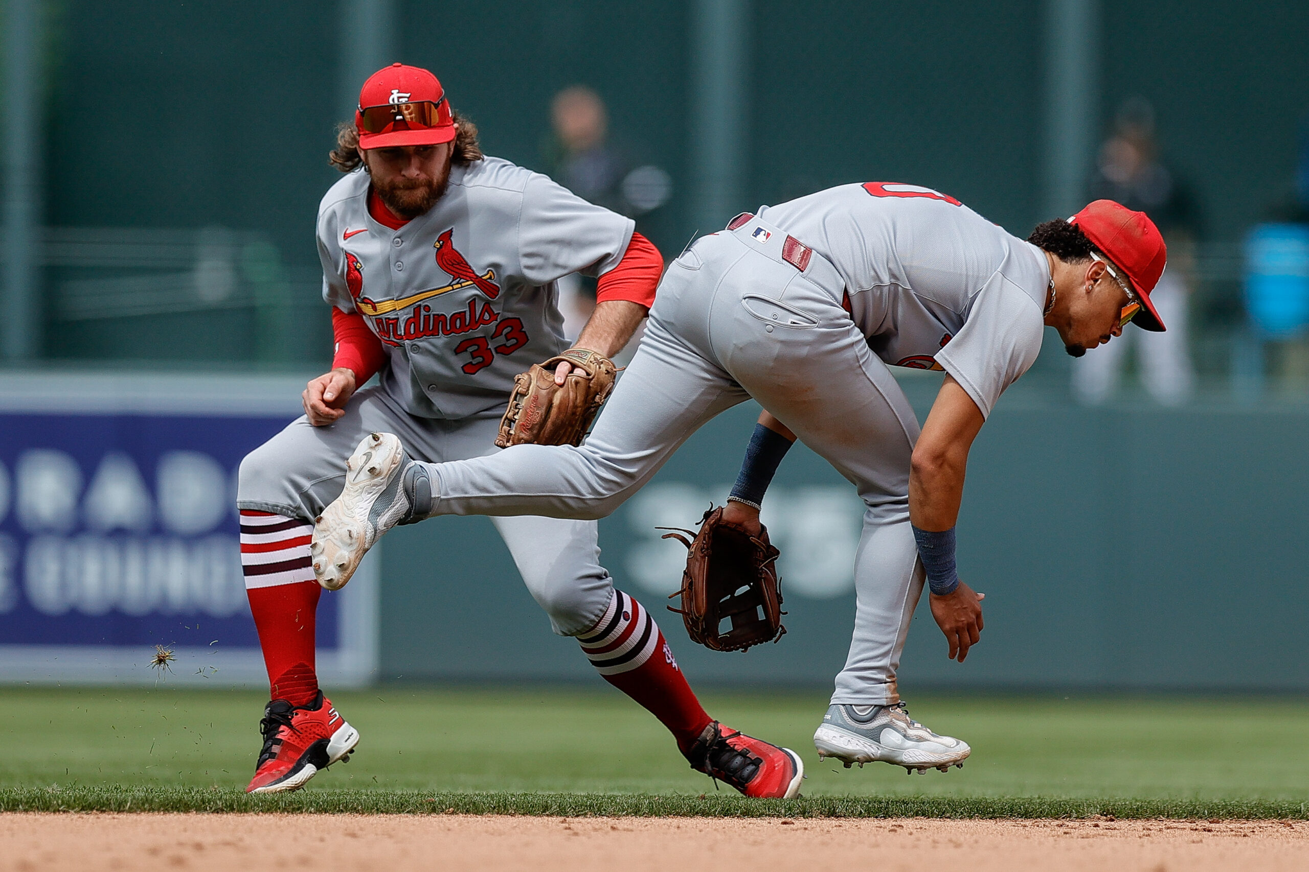 Jul 23, 2025; Denver, Colorado, USA; St. Louis Cardinals second baseman Brendan Donovan (33) fields the ball behind shortstop Masyn Winn (0) in the seventh inning against the Colorado Rockies at Coors Field. Mandatory Credit: Isaiah J. Downing-Imagn Images