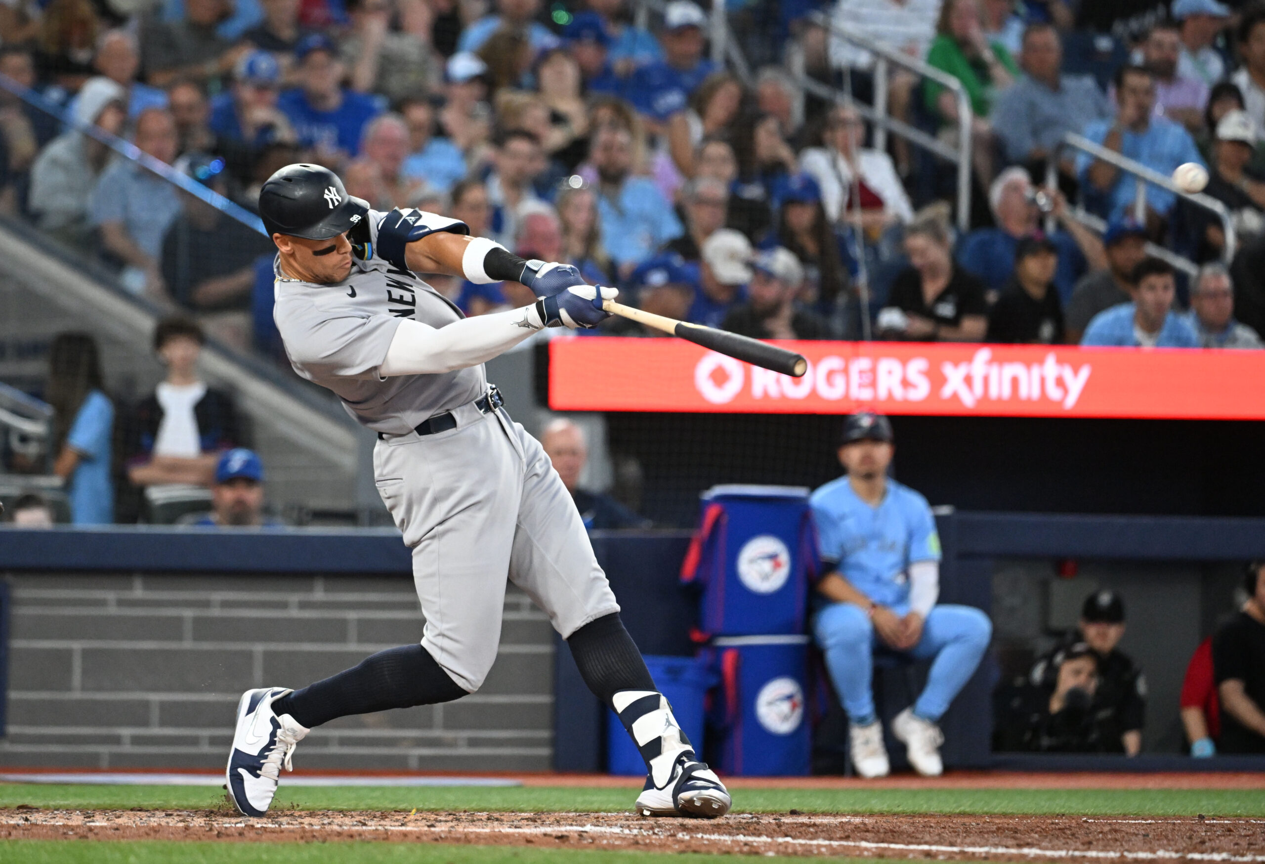 Jul 23, 2025; Toronto, Ontario, CAN;  New York Yankees designated hitter Aaron Judge (99) hits a two run home run against the Toronto Blue Jays in the sixth inning at Rogers Centre. Mandatory Credit: Dan Hamilton-Imagn Images