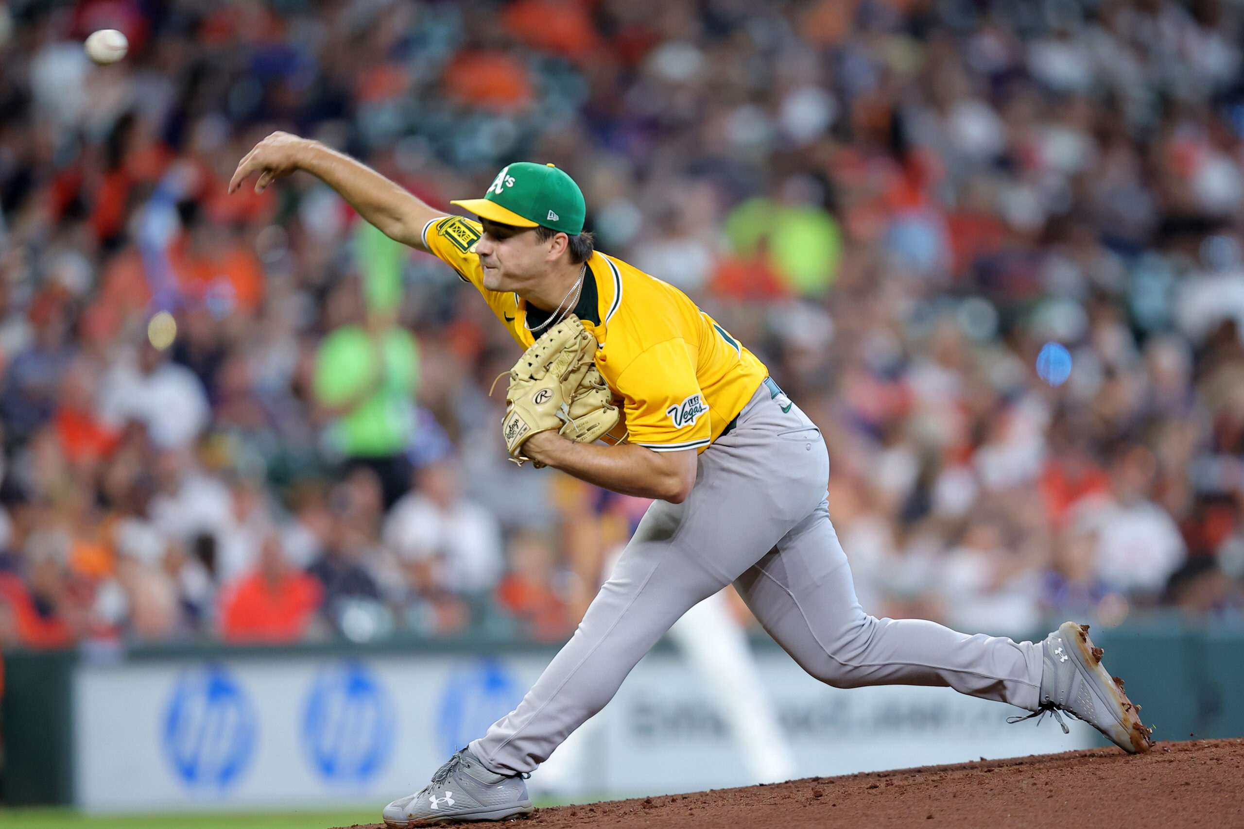 Jul 27, 2025; Houston, Texas, USA; Athletics starting pitcher J.T. Ginn (70) delivers a pitch against the Houston Astros during the first inning at Daikin Park. Mandatory Credit: Erik Williams-Imagn Images