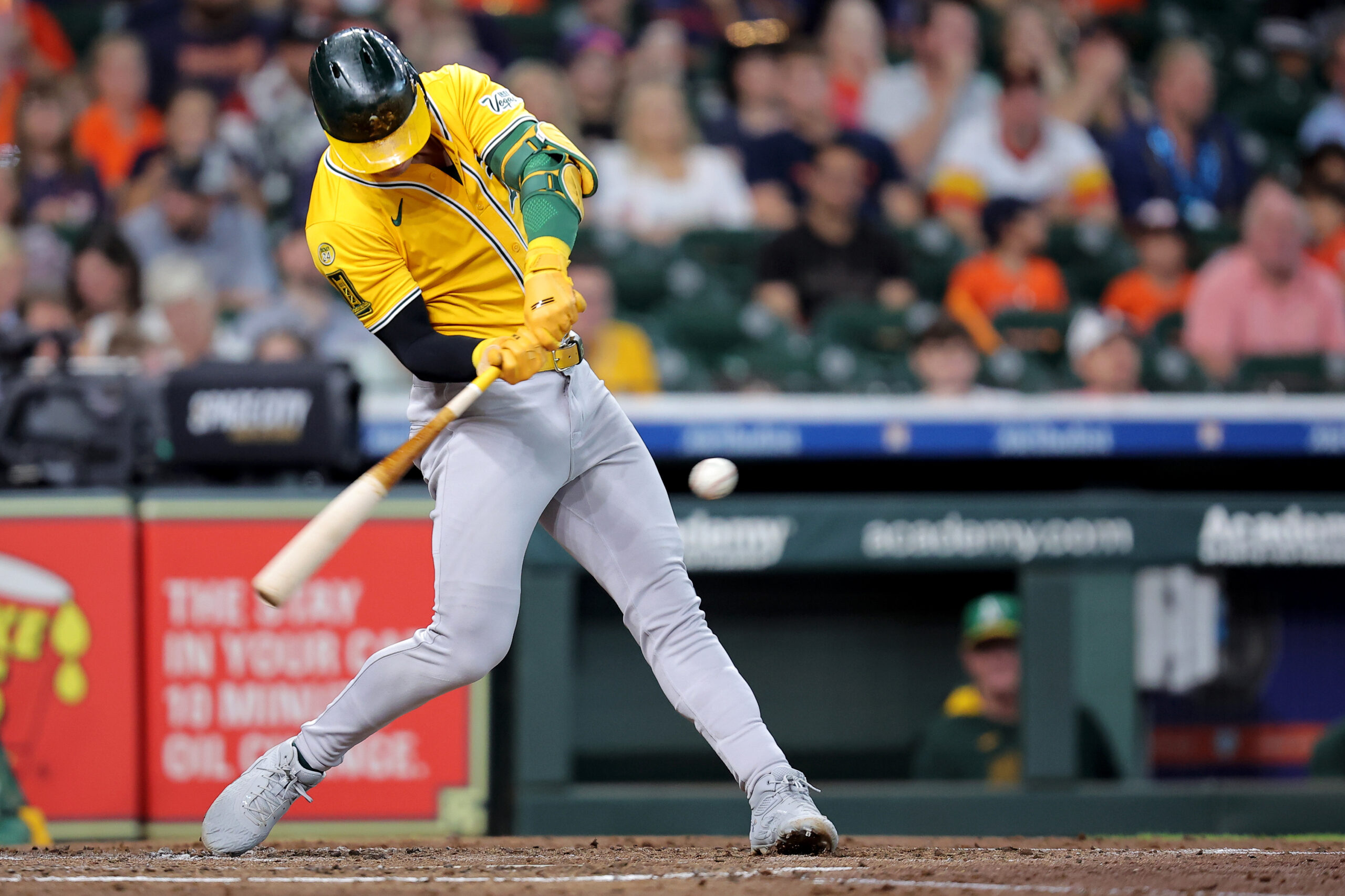 Jul 27, 2025; Houston, Texas, USA;  Athletics left fielder Brent Rooker (25) hits a single against the Houston Astros during the fourth inning at Daikin Park. Mandatory Credit: Erik Williams-Imagn Images