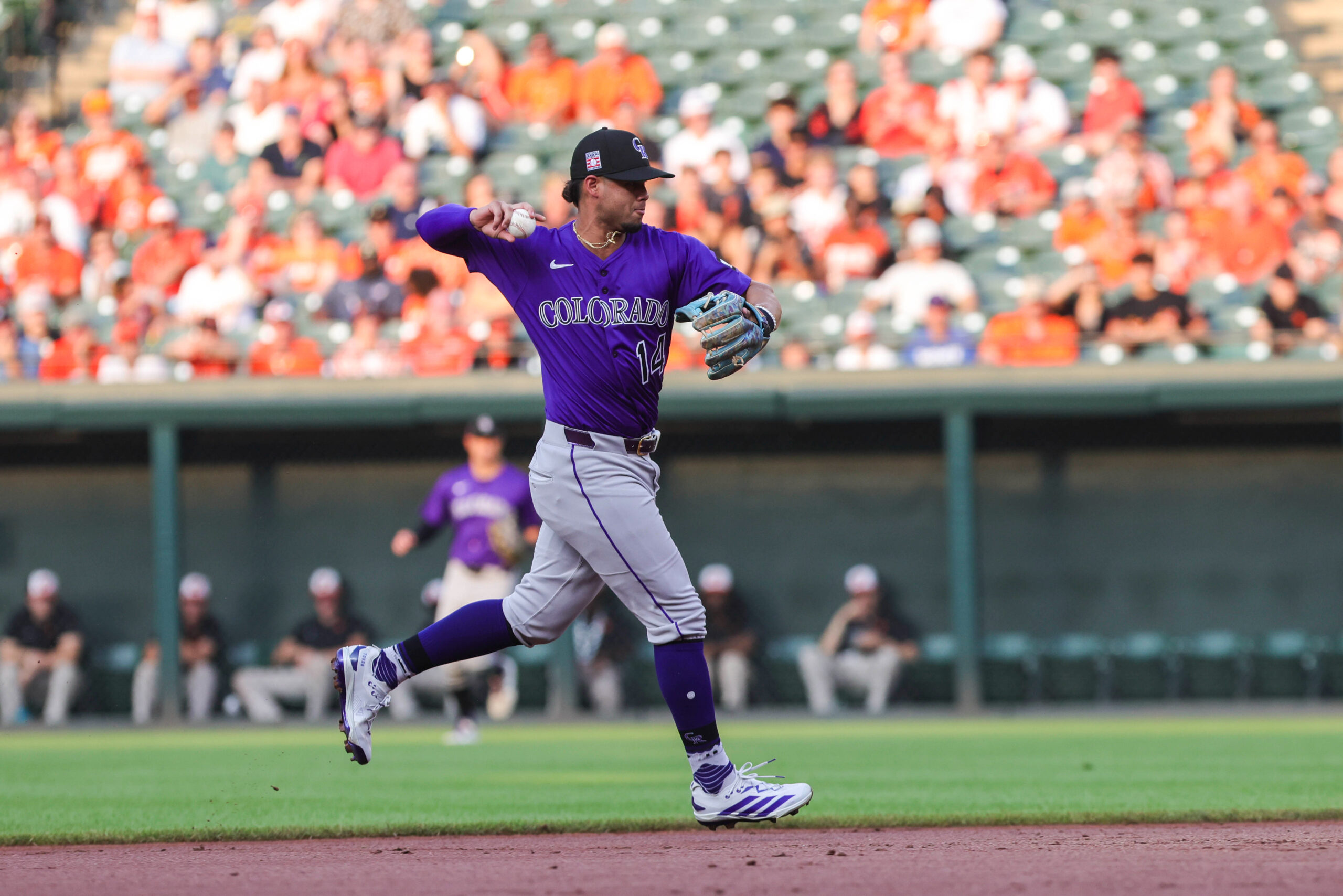Jul 26, 2025; Baltimore, Maryland, USA; Colorado Rockies  shortstop Ezequiel Tovar (14) making a play at first for the out against the Baltimore Orioles at Oriole Park at Camden Yards. Mandatory Credit: Lexi Thompson-Imagn Images