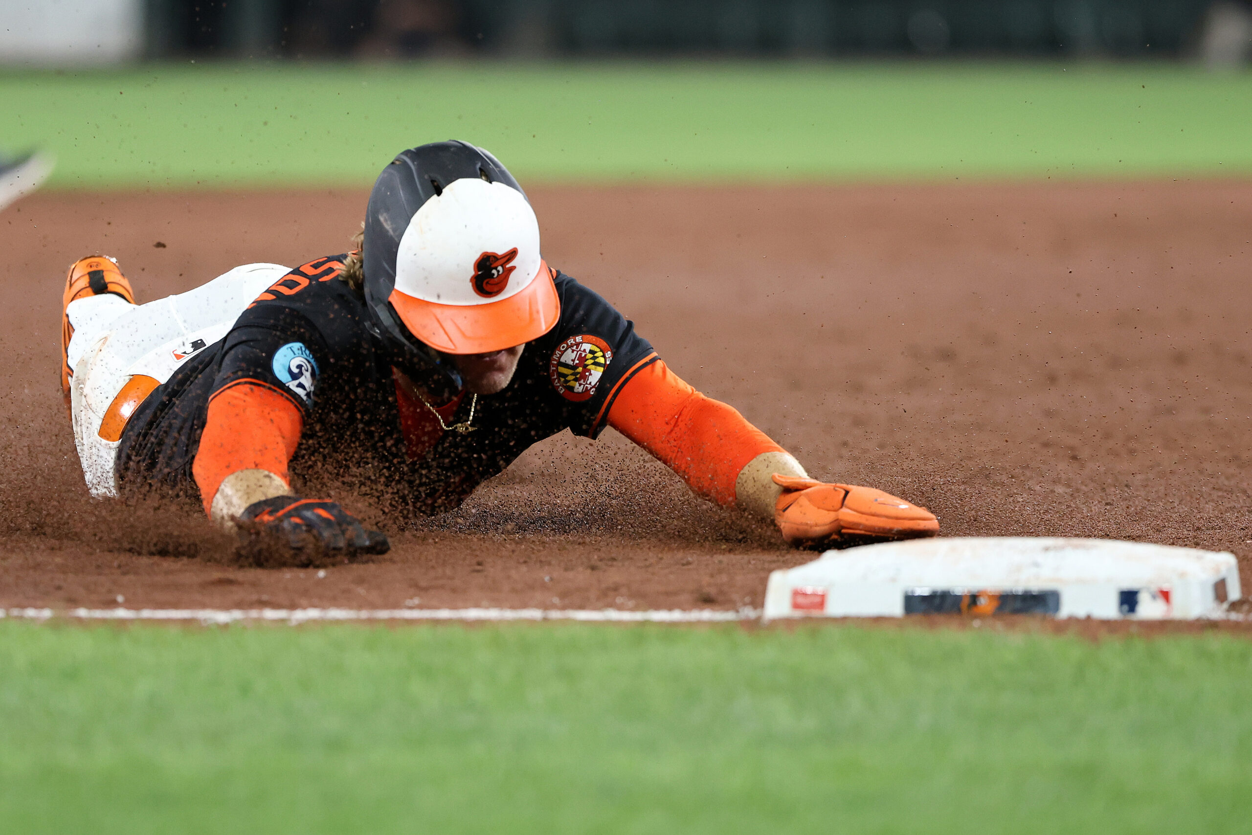 Jul 28, 2025; Baltimore, Maryland, USA; Baltimore Orioles shortstop Gunnar Henderson (2) slides into third base safely during the sixth inning against the Toronto Blue Jays at Oriole Park at Camden Yards. Mandatory Credit: Daniel Kucin Jr.-Imagn Images