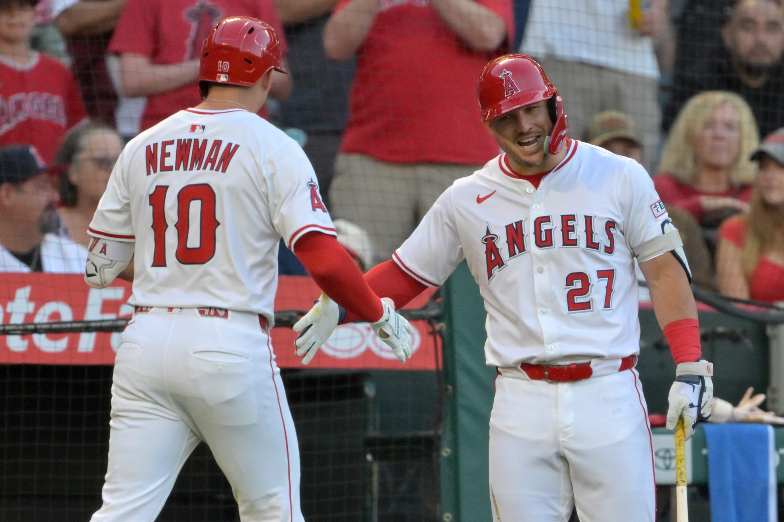 Jul 28, 2025; Anaheim, California, USA;  Los Angeles Angels third baseman Kevin Newman (10) is congratulated by designated hitter Mike Trout (27) after hitting a two-run home run during the third inning against the Texas Rangers at Angel Stadium. Mandatory Credit: Jayne Kamin-Oncea-Imagn Images