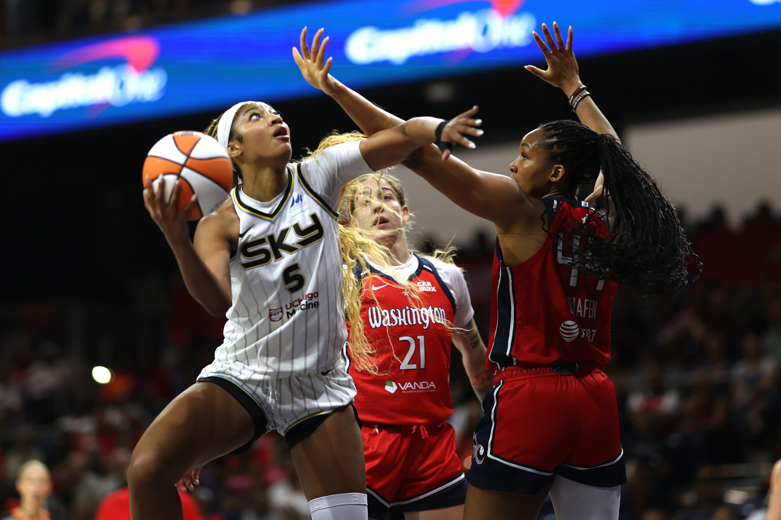 Jul 29, 2025; Washington, District of Columbia, USA; Chicago Sky forward Angel Reese (5) shoots the ball as Washington Mystics forward Kiki Iriafen (44) defends in the first half at CareFirst Arena. Mandatory Credit: Geoff Burke-Imagn Images