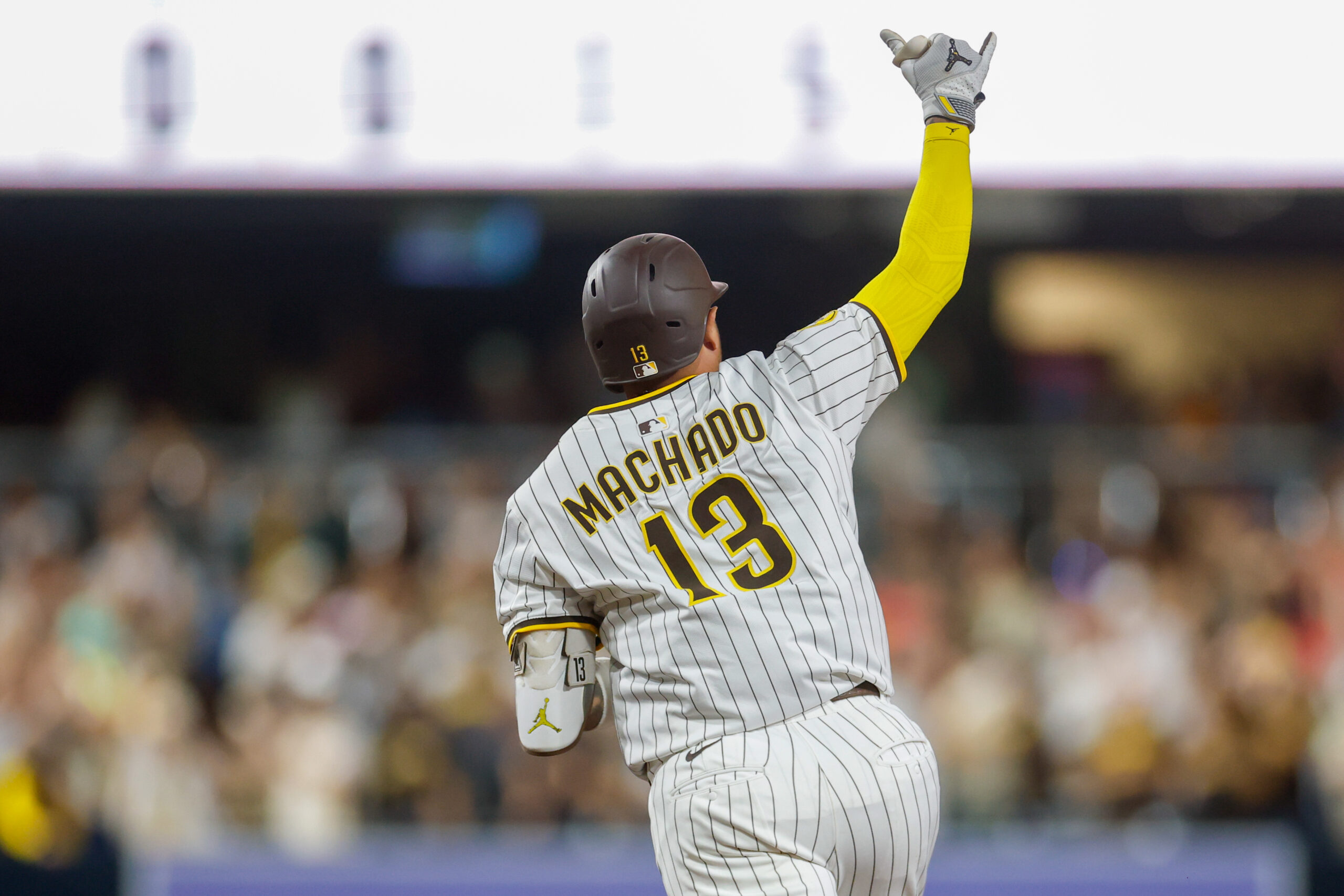Jul 29, 2025; San Diego, California, USA; San Diego Padres designated hitter Manny Machado (13) celebrates after hitting a three-run home run during the seventh inning against the New York Mets at Petco Park. Mandatory Credit: David Frerker-Imagn Images