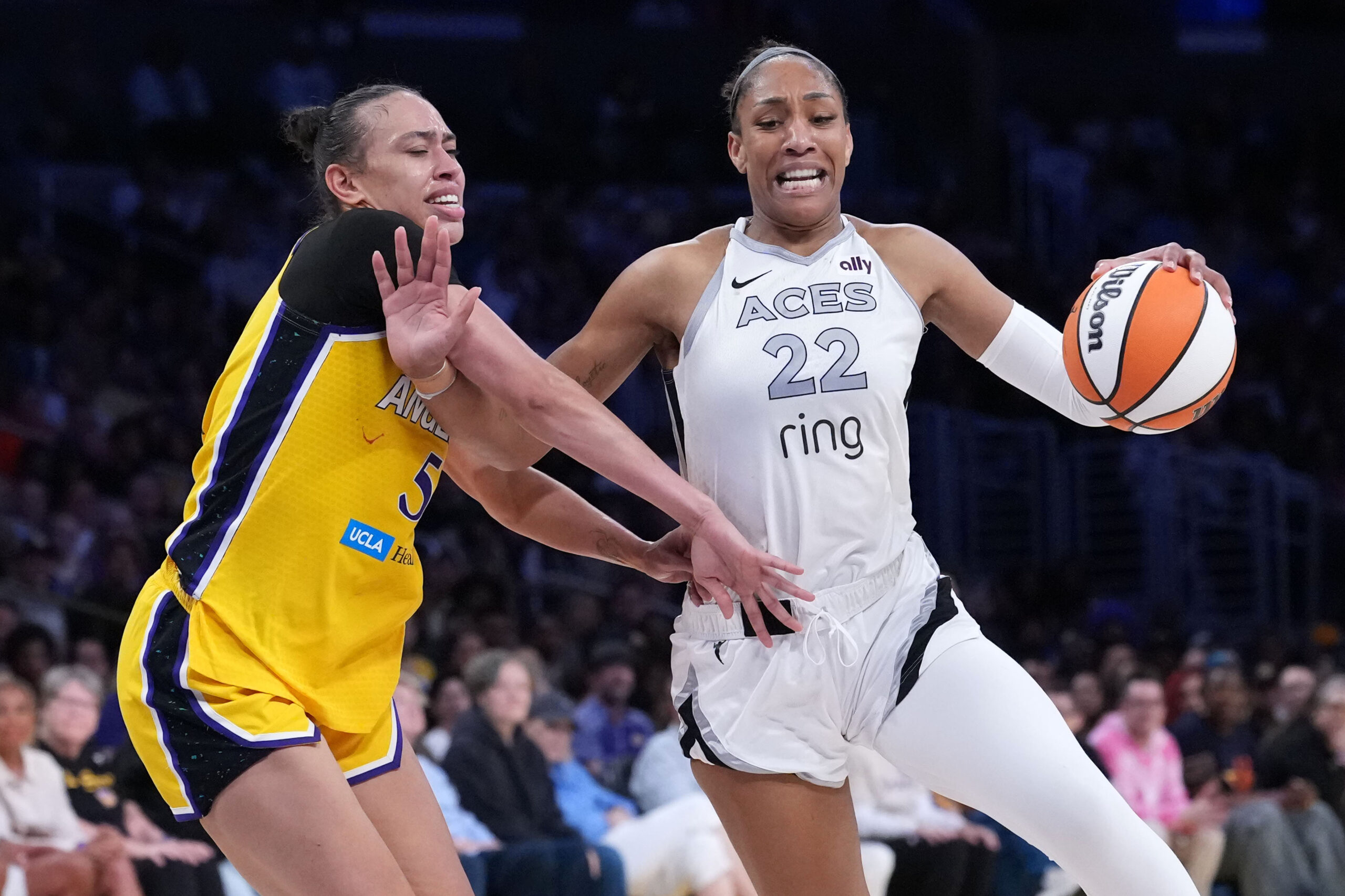 Jul 29, 2025; Los Angeles, California, USA; Las Vegas Aces center A'ja Wilson (22) dribbles the ball against LA Sparks forward Dearica Hamby (5) in the second half at the Crypto.com Arena. Mandatory Credit: Kirby Lee-Imagn Images