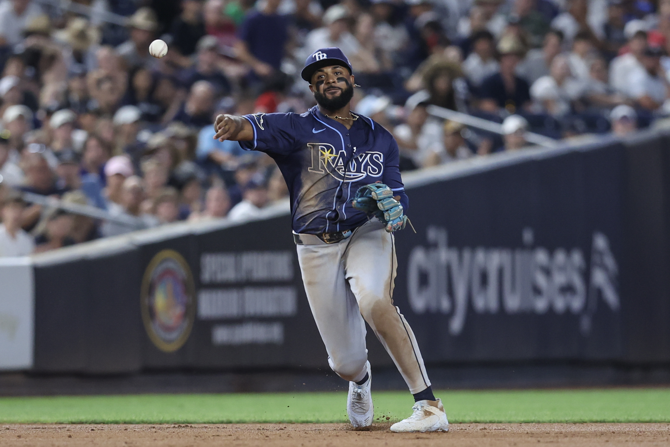 Jul 30, 2025; Bronx, New York, USA;  Tampa Bay Rays third baseman Junior Caminero (13) throws a runner out at first base in the sixth inning against the New York Yankees at Yankee Stadium. Mandatory Credit: Wendell Cruz-Imagn Images