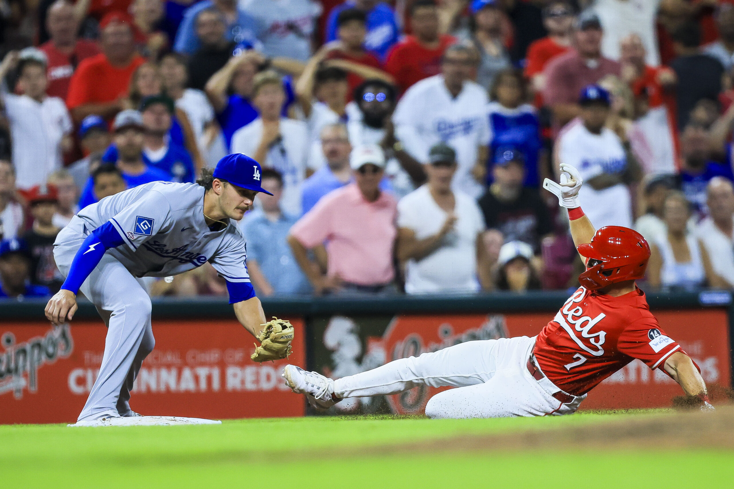 Jul 30, 2025; Cincinnati, Ohio, USA; Cincinnati Reds first baseman Spencer Steer (7) slides into third after hitting a two-run triple in the eighth inning against the Los Angeles Dodgers at Great American Ball Park. Mandatory Credit: Katie Stratman-Imagn Images