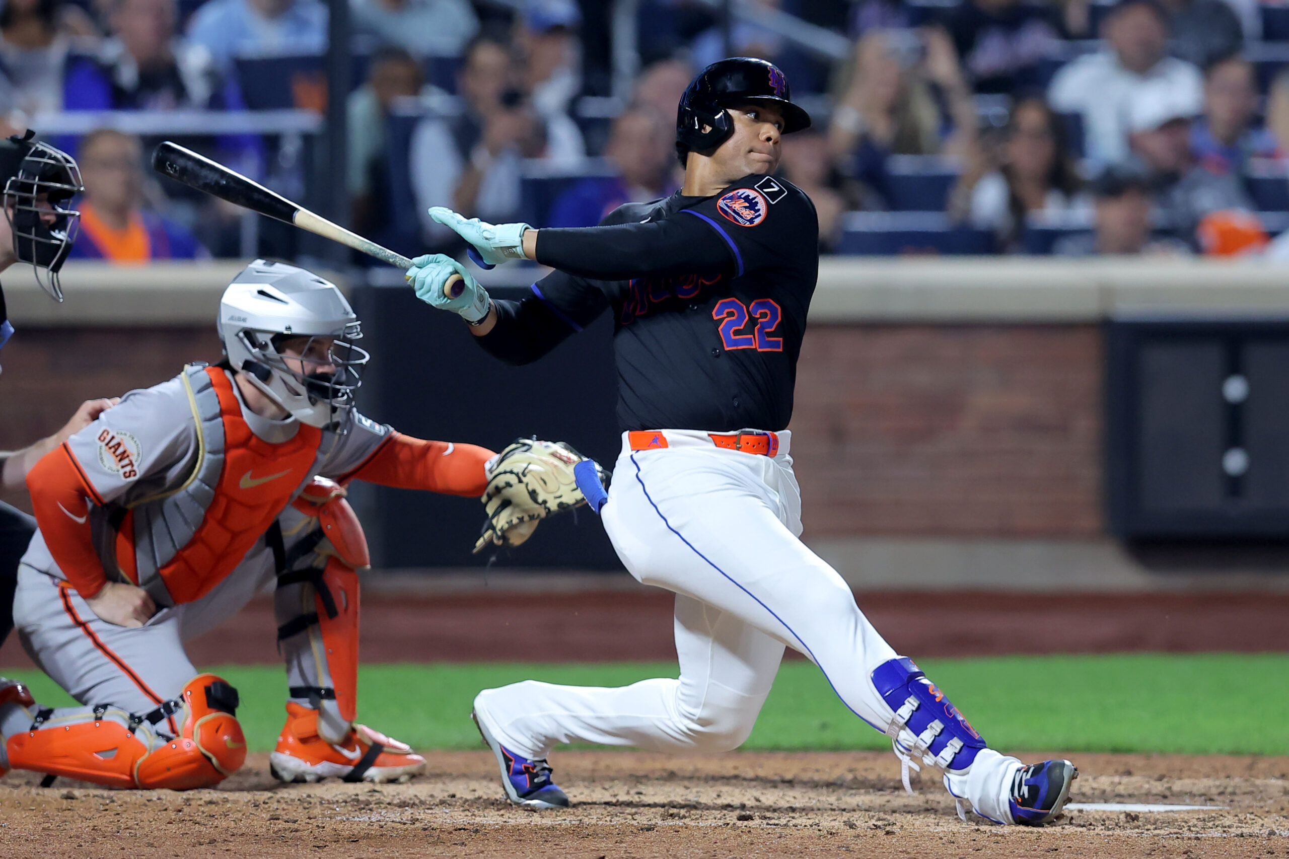 Aug 1, 2025; New York City, New York, USA; New York Mets right fielder Juan Soto (22) follows through on an RBI single against the San Francisco Giants during the eighth inning at Citi Field. Mandatory Credit: Brad Penner-Imagn Images
