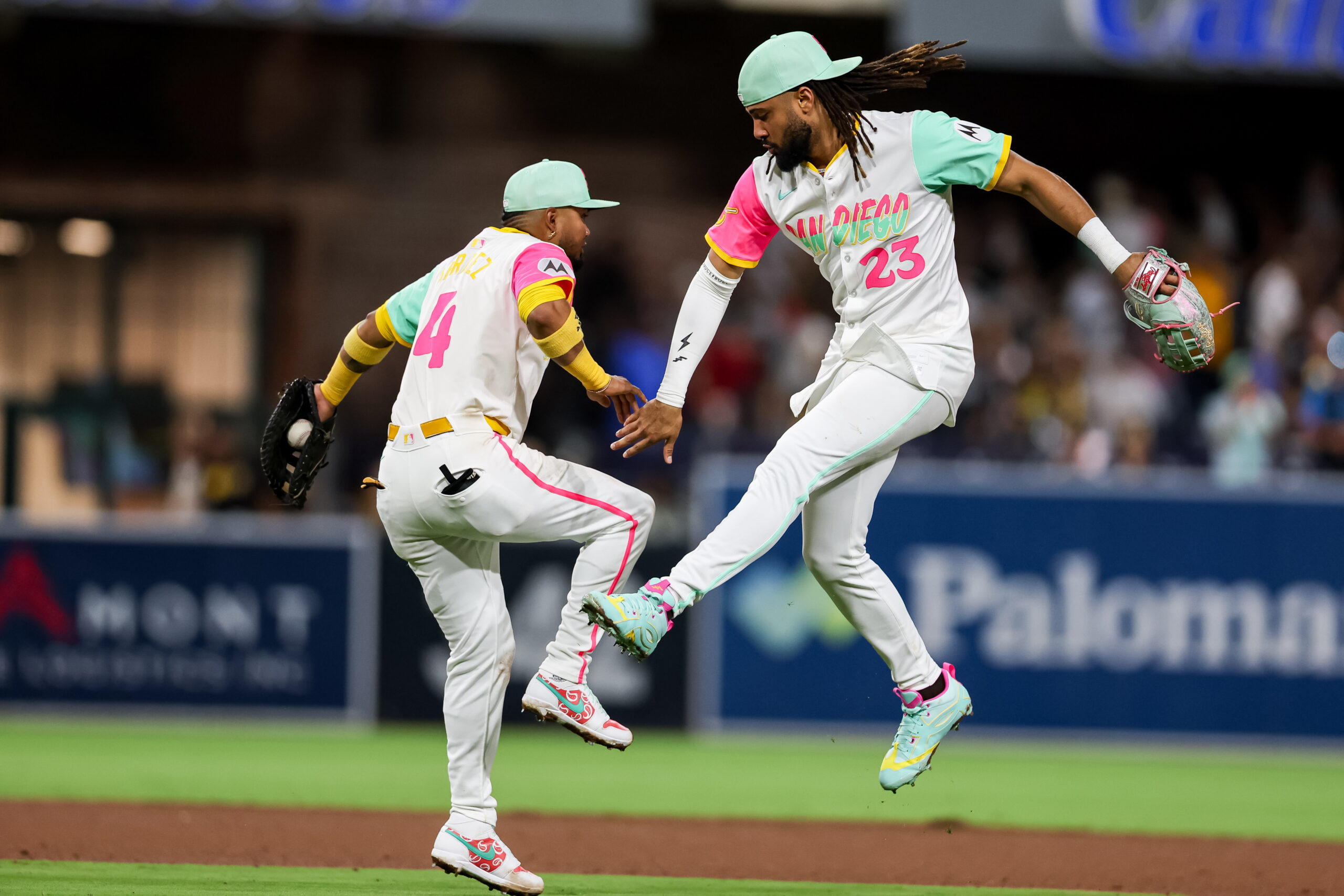 Aug 1, 2025; San Diego, California, USA; San Diego Padres right fielder Fernando Tatis Jr. (23) and first baseman Luis Arraez (4) high five after defeating the St. Louis Cardinals at Petco Park. Mandatory Credit: Chadd Cady-Imagn Images
