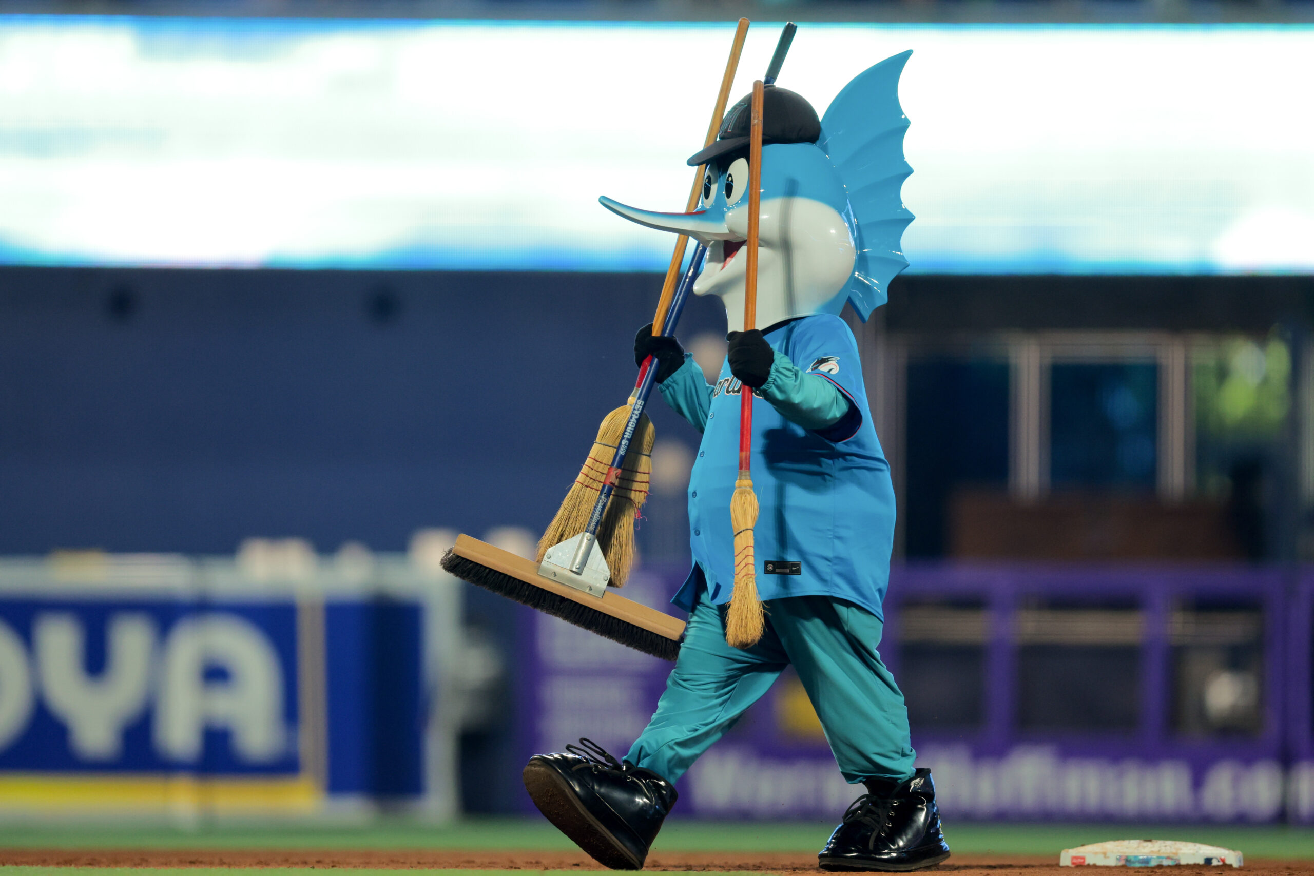 Aug 3, 2025; Miami, Florida, USA; Miami Marlins mascot Billy the Marlins walks with three brooms after the Miami Marlins swept the New York Yankees at loanDepot Park. Mandatory Credit: Sam Navarro-Imagn Images