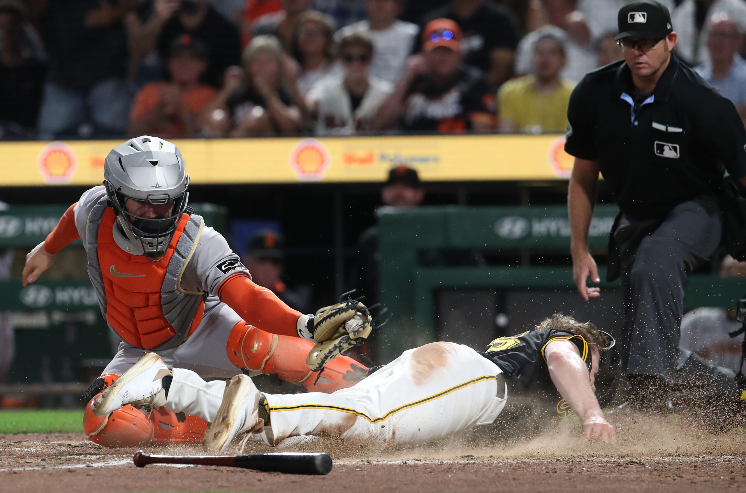 Aug 4, 2025; Pittsburgh, Pennsylvania, USA;  Pittsburgh Pirates right fielder Jack Suwinski (right) slides past San Francisco Giants catcher Patrick Bailey (14) to score the game winning run during the ninth inning at PNC Park. Mandatory Credit: Charles LeClaire-Imagn Images