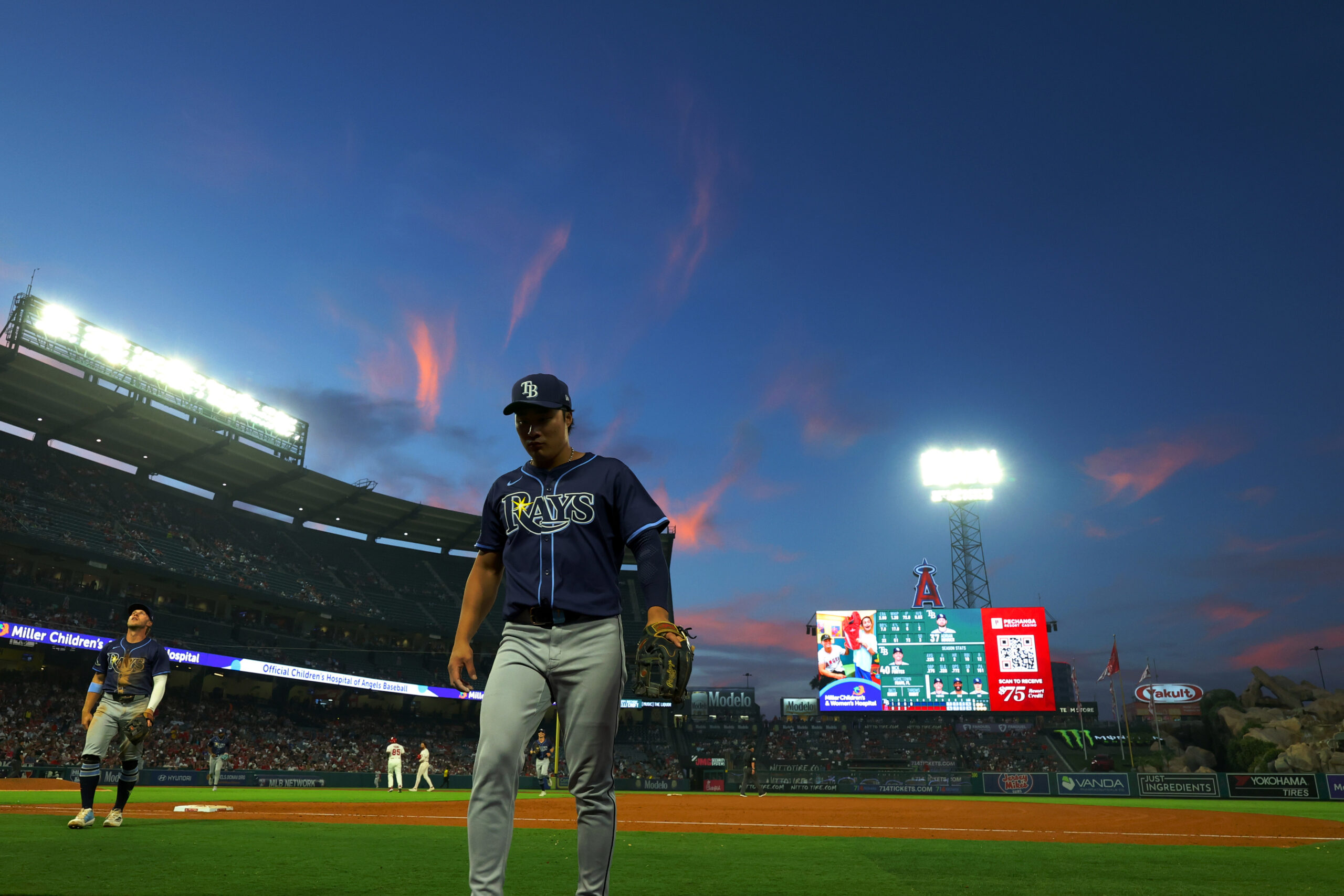 Aug 4, 2025; Anaheim, California, USA;  Tampa Bay Rays second baseman Ha-Seong Kim (7) walks back to the dugout between the fourth inning against the Los Angeles Angels at Angel Stadium. Mandatory Credit: Kiyoshi Mio-Imagn Images