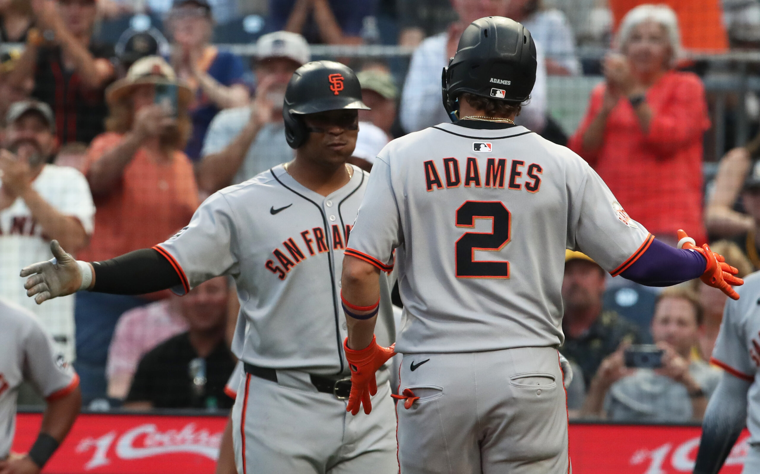 Aug 5, 2025; Pittsburgh, Pennsylvania, USA;  San Francisco Giants designated hitter Rafael Devers (left) greets shortstop Willy Adames (2) crossing home plate on on a two run home run against the Pittsburgh Pirates during the fifth inning at PNC Park. Mandatory Credit: Charles LeClaire-Imagn Images