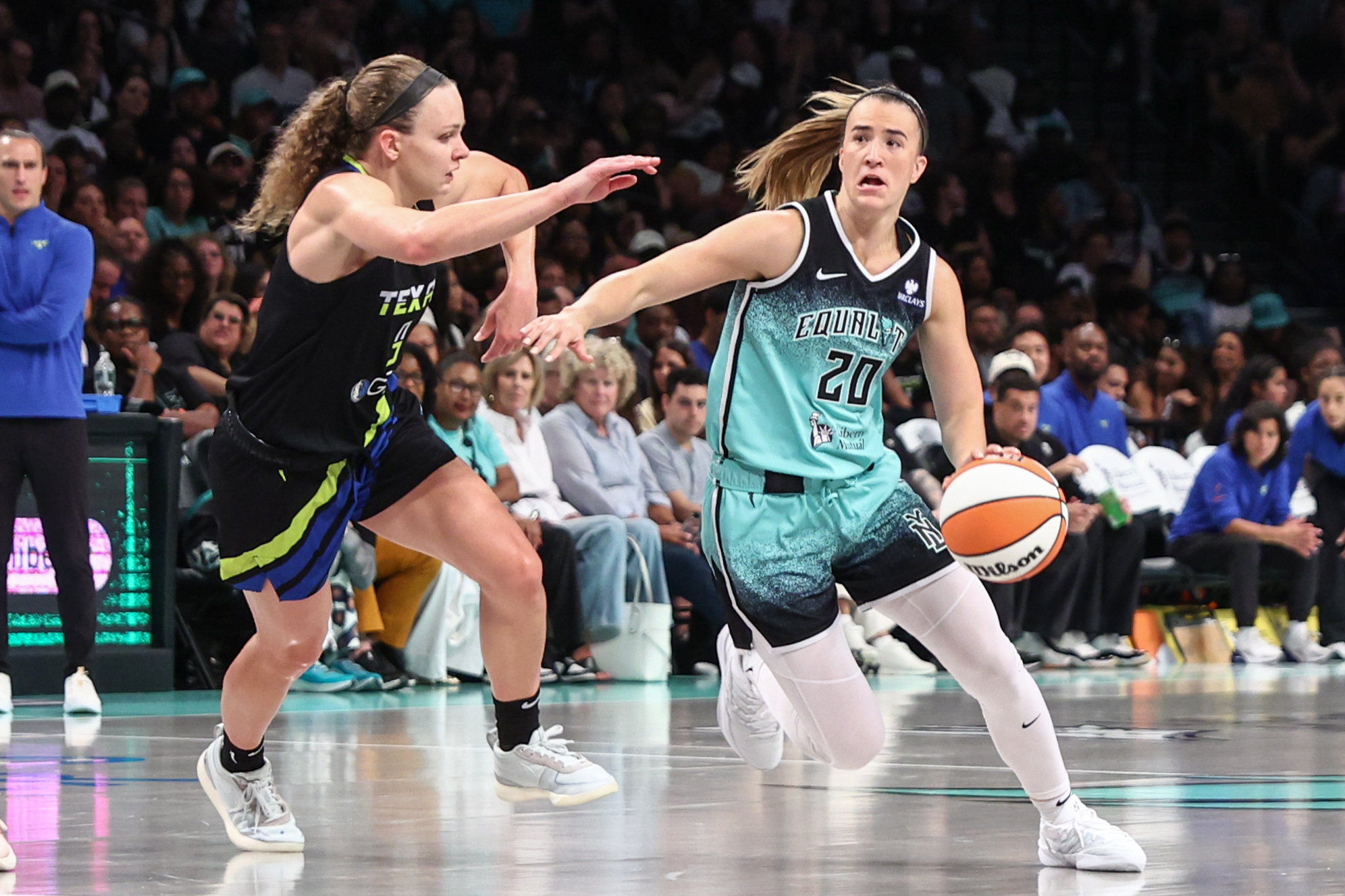 Aug 5, 2025; Brooklyn, New York, USA;  New York Liberty guard Sabrina Ionescu (20) looks to drive past Dallas Wings guard Grace Berger (9) in the third quarter at Barclays Center. Mandatory Credit: Wendell Cruz-Imagn Images