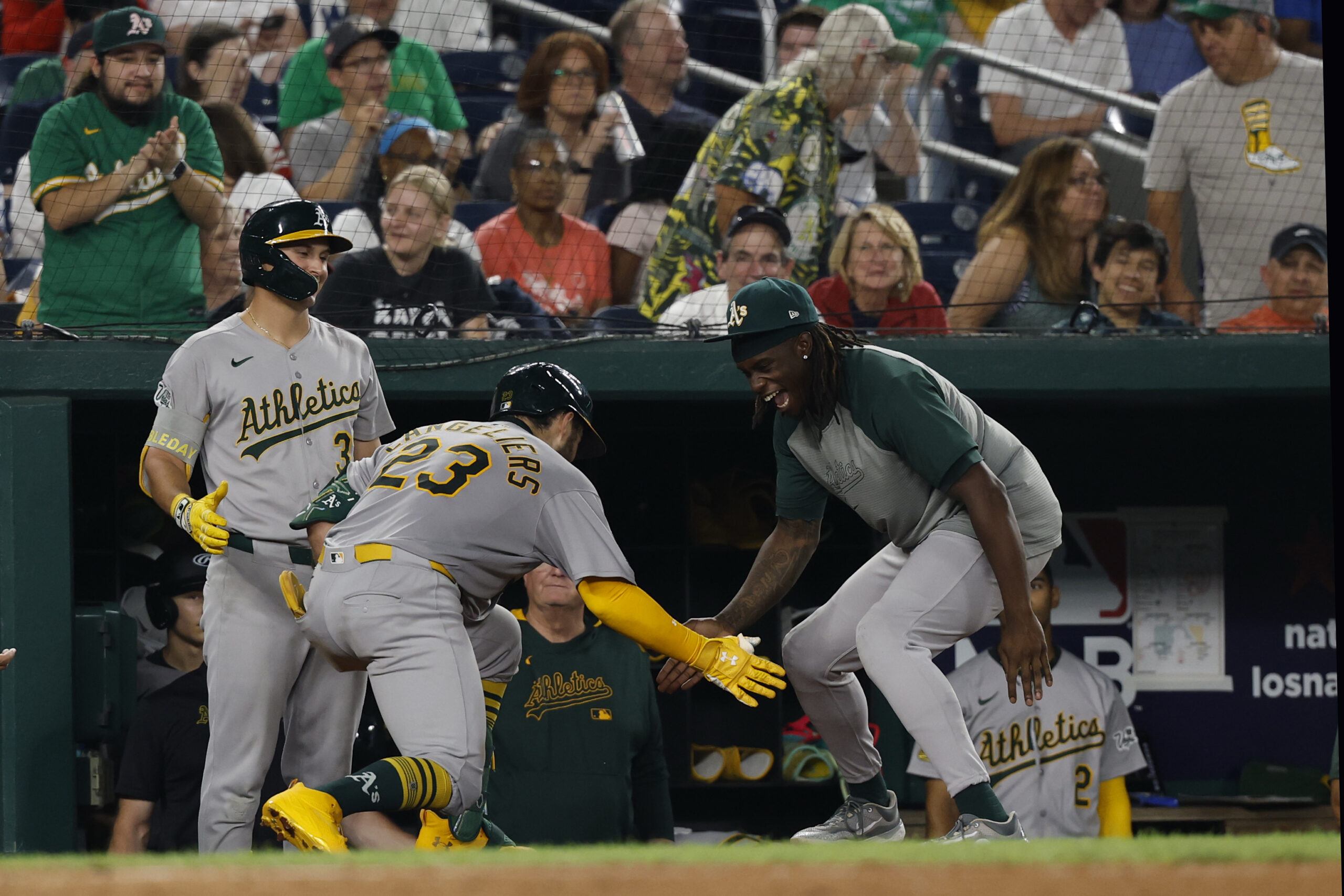 Aug 5, 2025; Washington, District of Columbia, USA; Athletics catcher Shea Langeliers (23) celebrates with teammates in the dugout after hitting a home run against the Washington Nationals during the seventh inning at Nationals Park. Mandatory Credit: Geoff Burke-Imagn Images