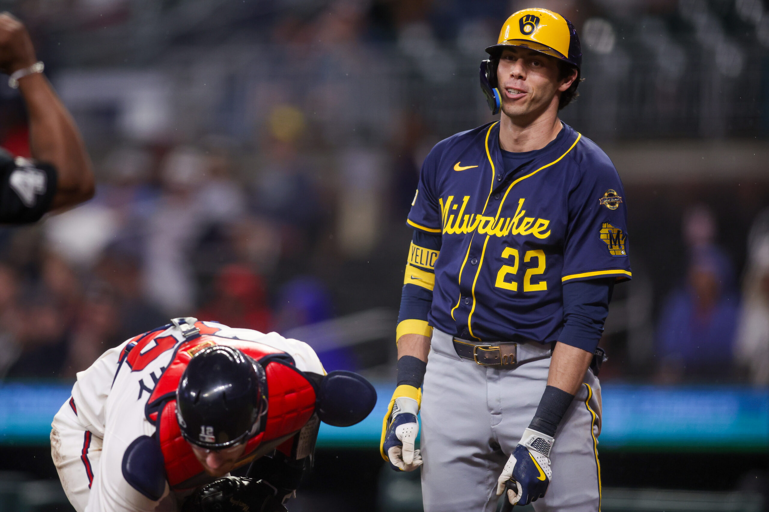 Aug 5, 2025; Atlanta, Georgia, USA; Milwaukee Brewers left fielder Christian Yelich (22) reacts after being tagged out by Atlanta Braves catcher Sean Murphy (12) in the ninth inning at Truist Park. Mandatory Credit: Brett Davis-Imagn Images