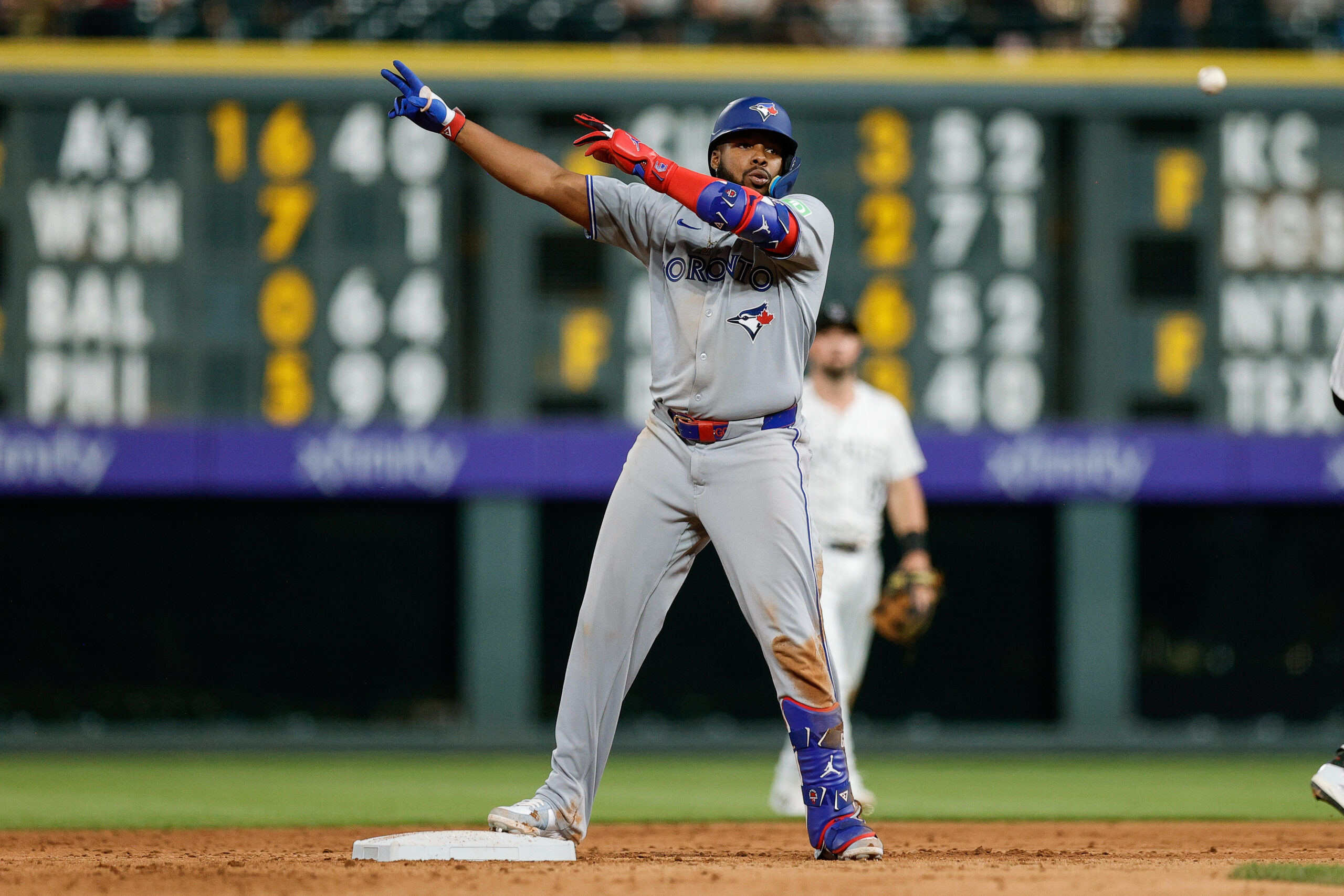Aug 5, 2025; Denver, Colorado, USA; Toronto Blue Jays first baseman Vladimir Guerrero Jr. (27) reacts from second on an RBI double in the ninth inning against the Colorado Rockies at Coors Field. Mandatory Credit: Isaiah J. Downing-Imagn Images