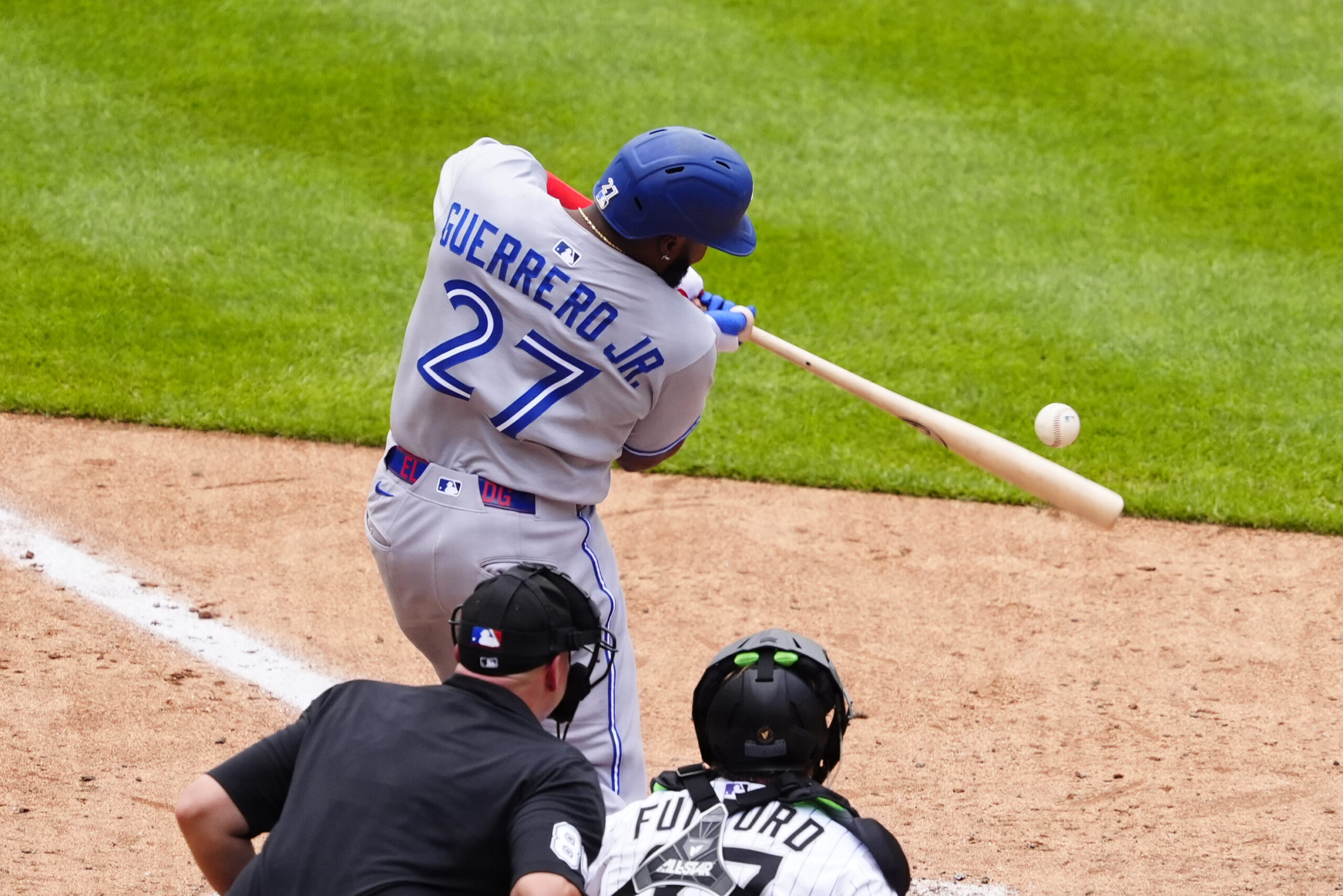 Aug 6, 2025; Denver, Colorado, USA; Toronto Blue Jays first base Vladimir Guerrero Jr. (27) doubles in the ninth inning against the Colorado Rockies at Coors Field. Mandatory Credit: Ron Chenoy-Imagn Images